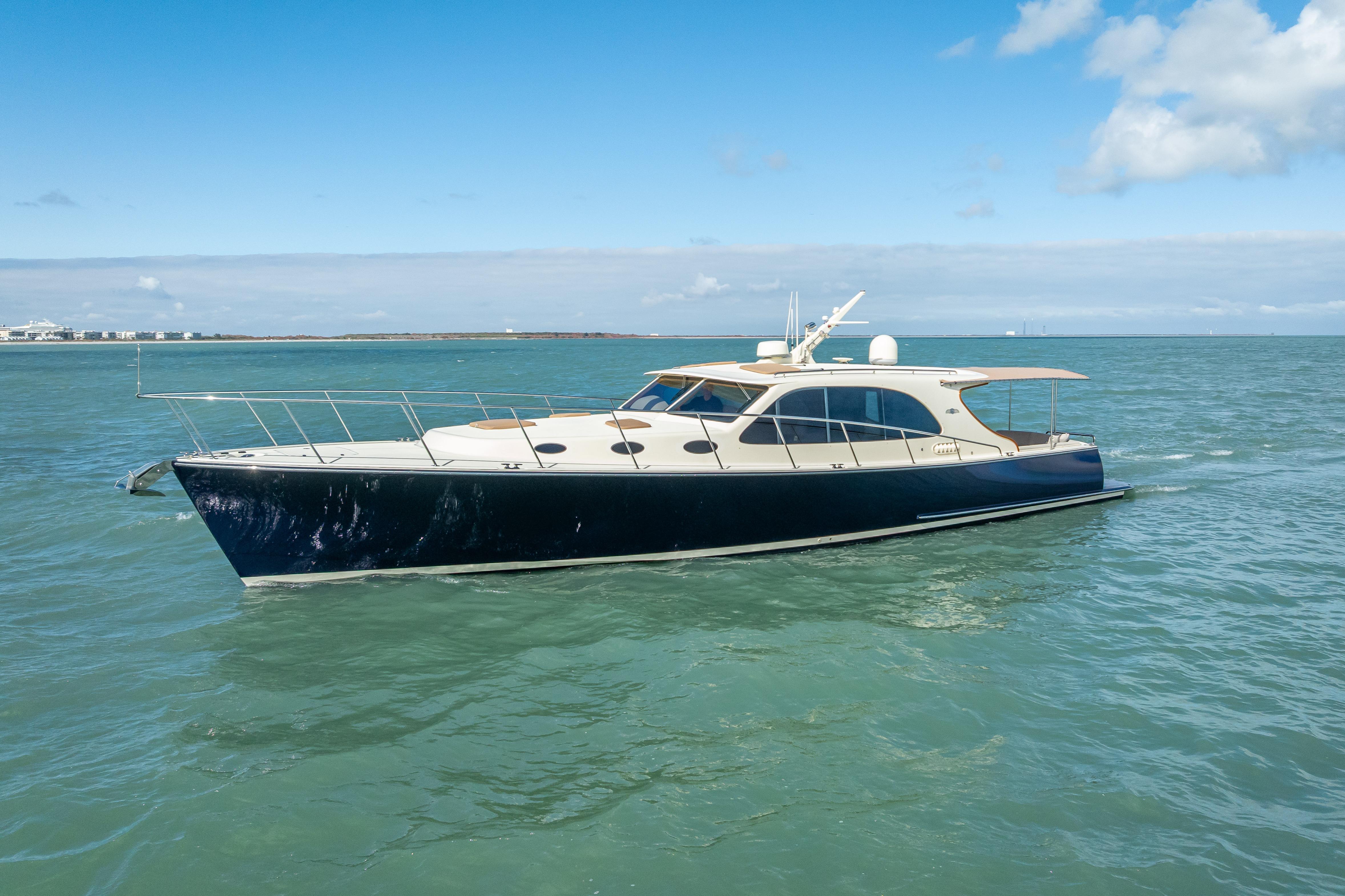 2018 Palm Beach Motor Yachts PB50 cruising on open water under blue skies.