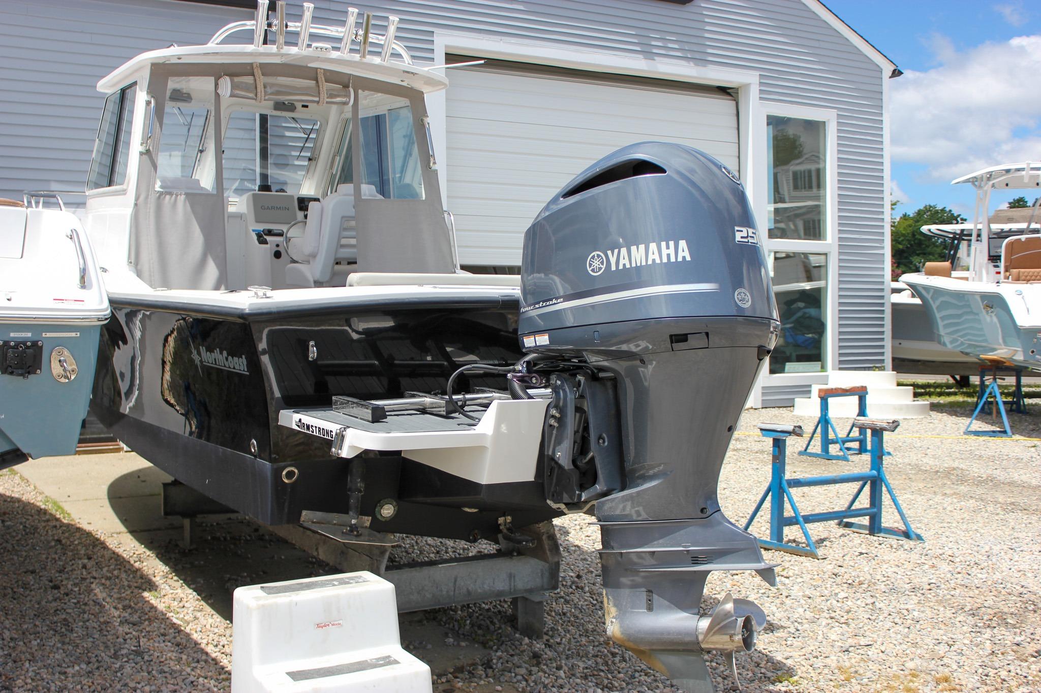 2022 NorthCoast 235 Cabin boat with Yamaha 215 engine, displayed outdoors.