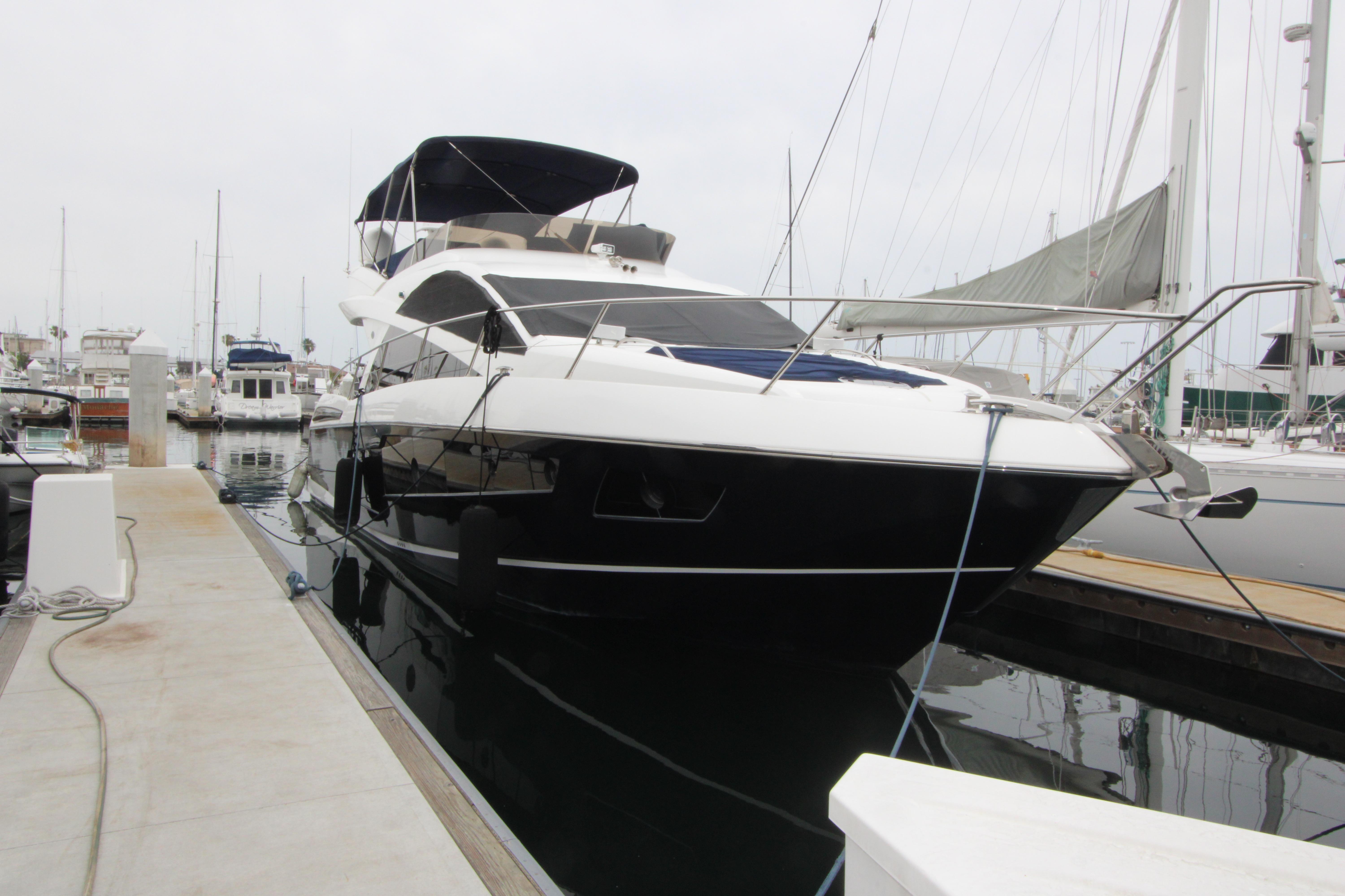 2014 Sunseeker Manhattan 55 yacht docked at marina, front view.