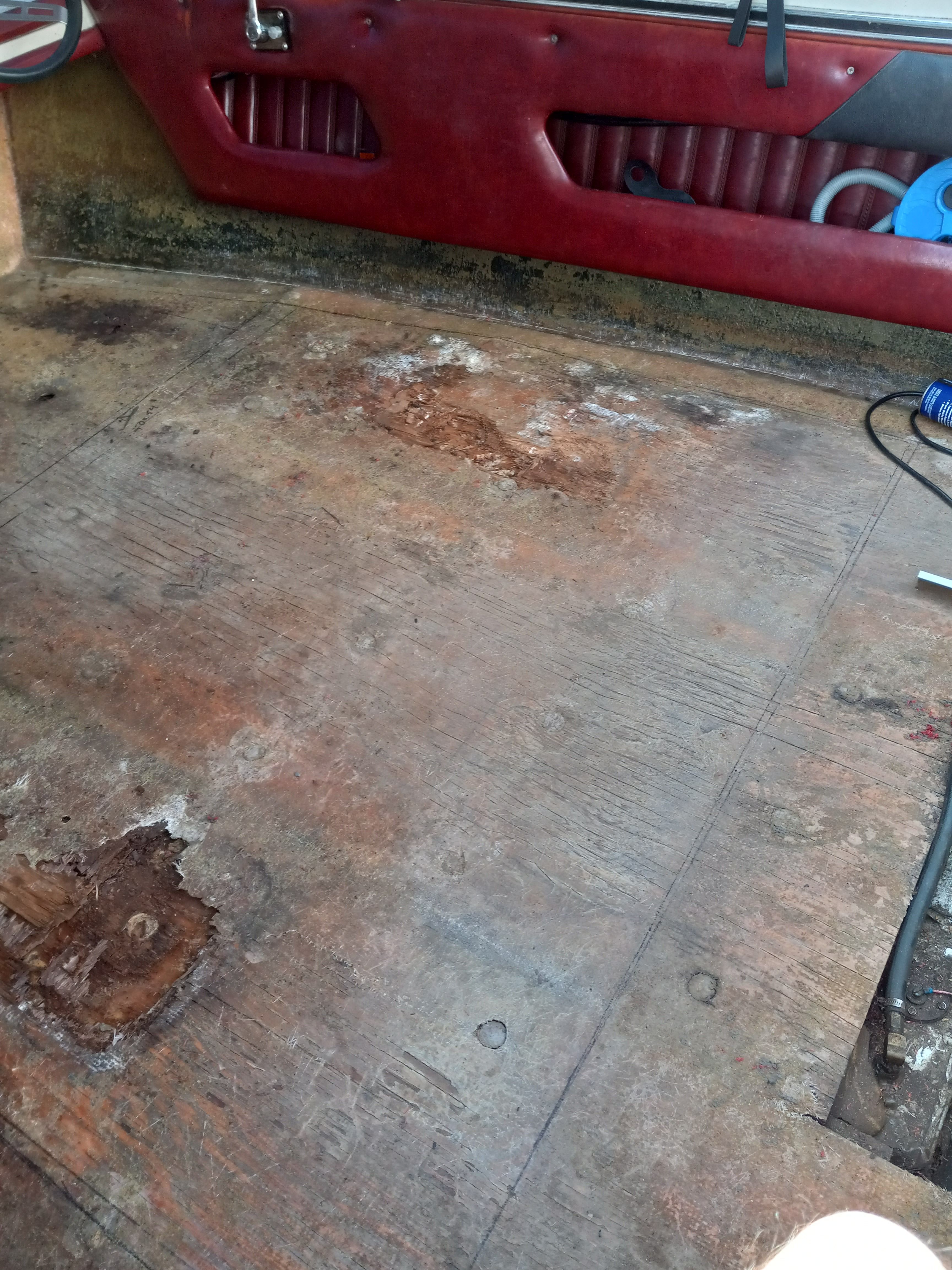 Interior of a 1977 Bayliner Jamaica boat with worn flooring.
