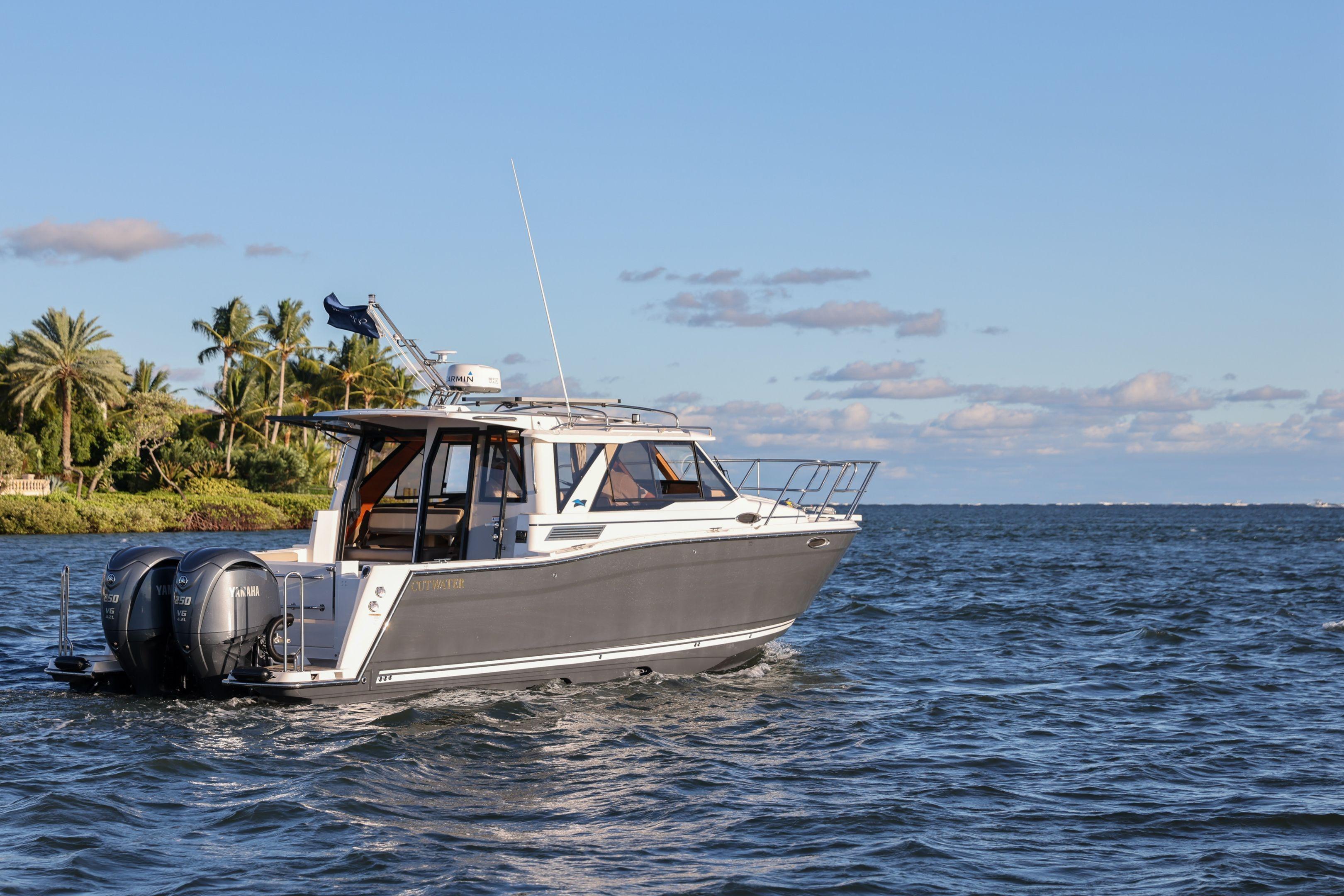 2026 Cutwater C-288 Coupe cruising on a sunny day, showcasing sleek design and powerful engines.
