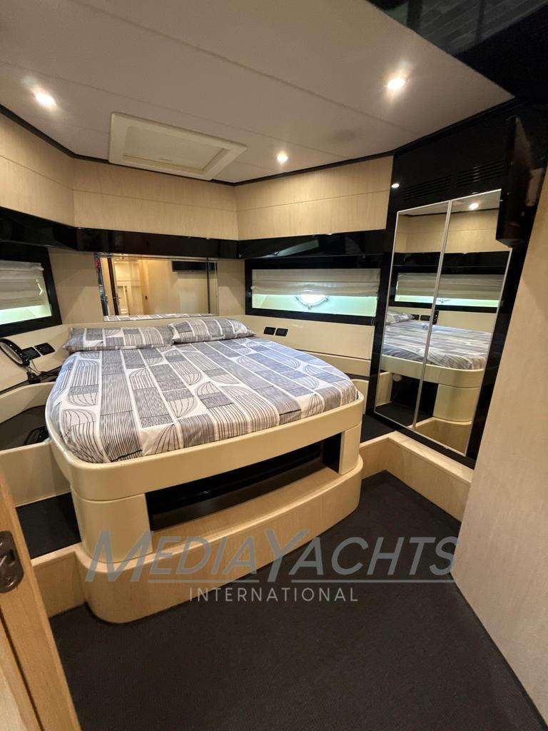 Luxurious bedroom interior of 2007 Riva Venere 75 yacht with modern design and cozy bed.