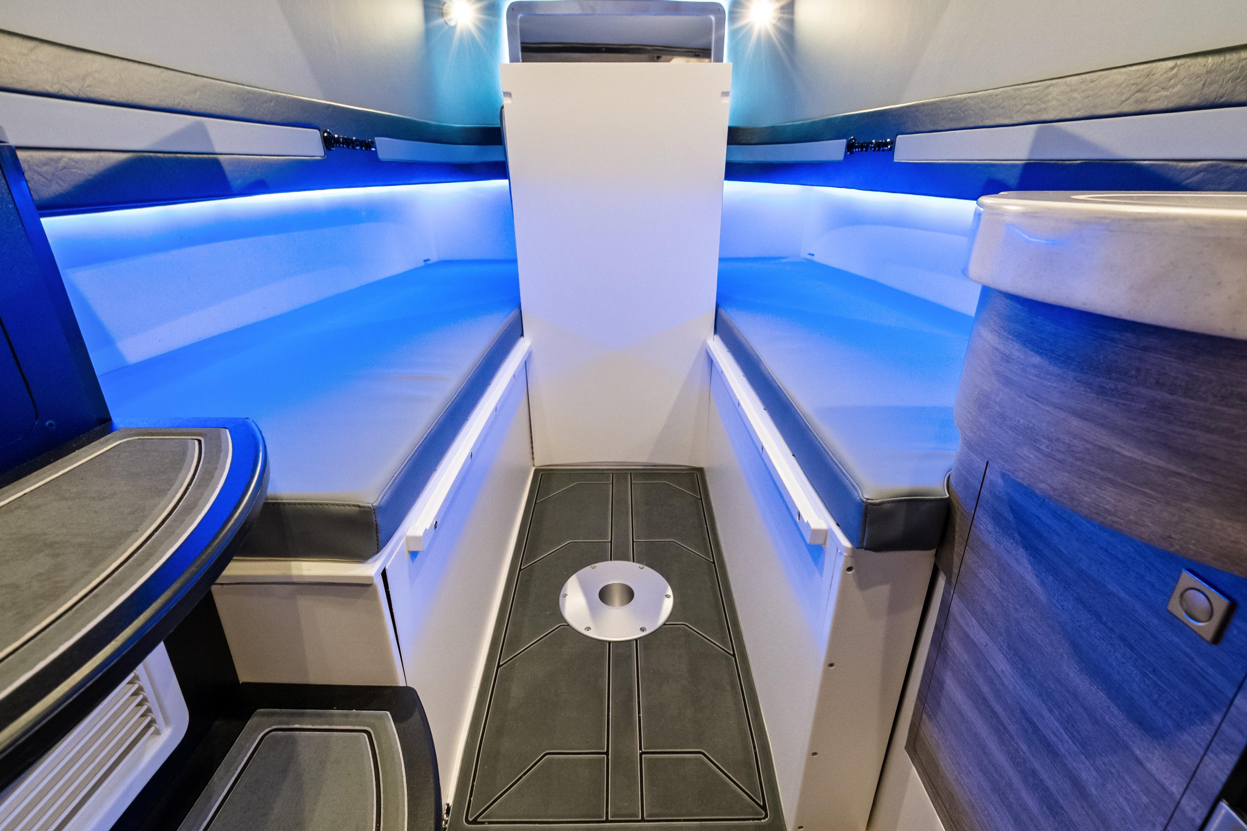 Interior of 2027 Mystic Powerboats M4200 with modern seating and ambient blue lighting.