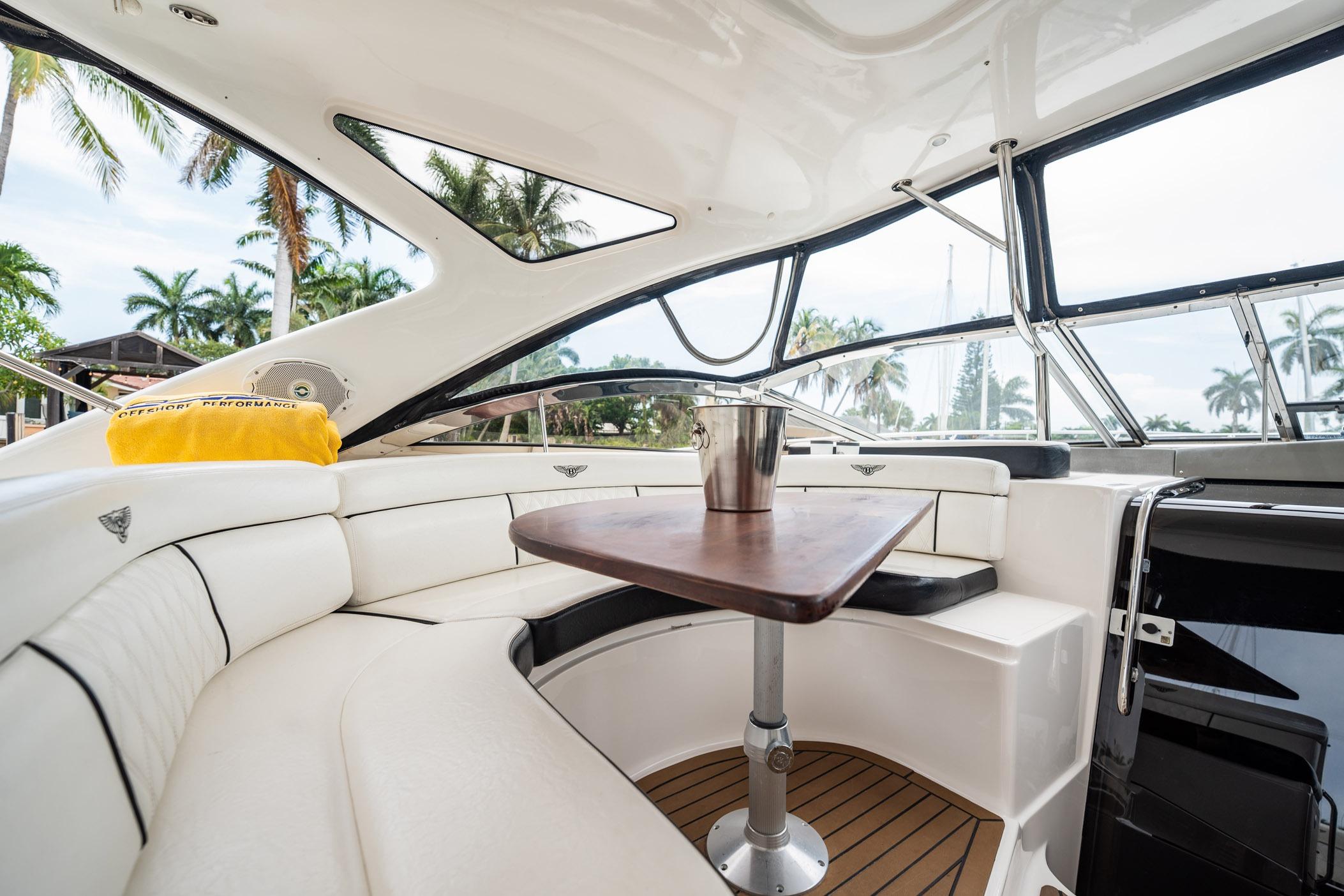 Luxurious interior of 2008 Regal Commodore 4460 yacht with elegant seating and table.