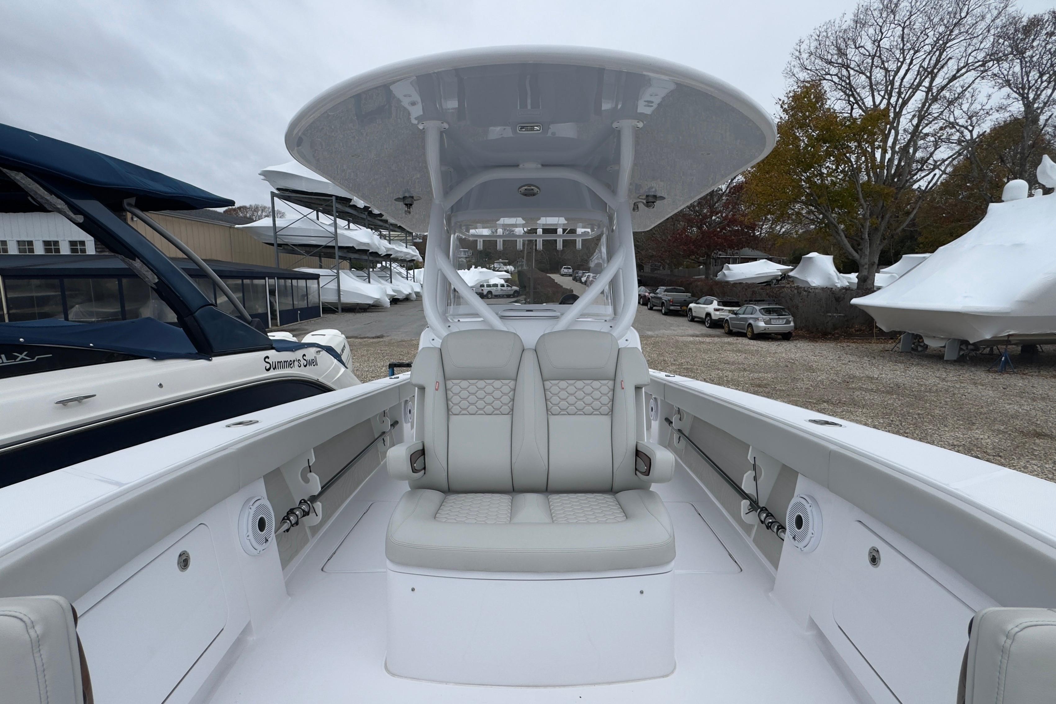 2024 Jupiter 32 FS boat interior with seating and console, docked outdoors.