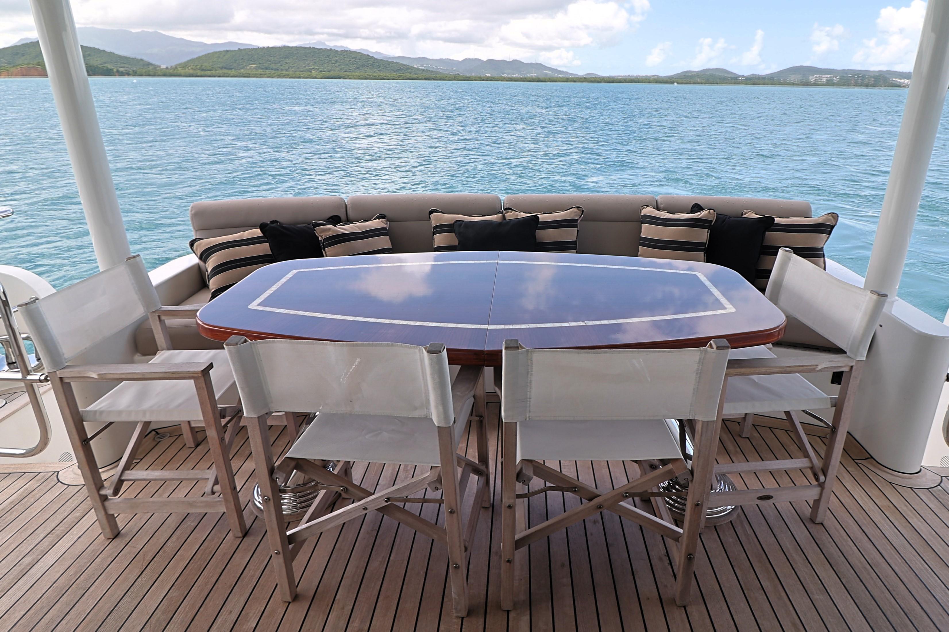 Outdoor dining area on 2013 Cheoy Lee Bravo yacht with ocean view.