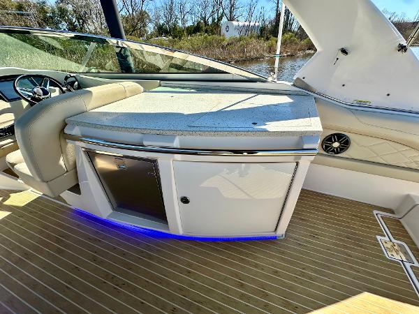 The image shows the cockpit of a 2018 Regal 3300 with a sleek kitchenette.