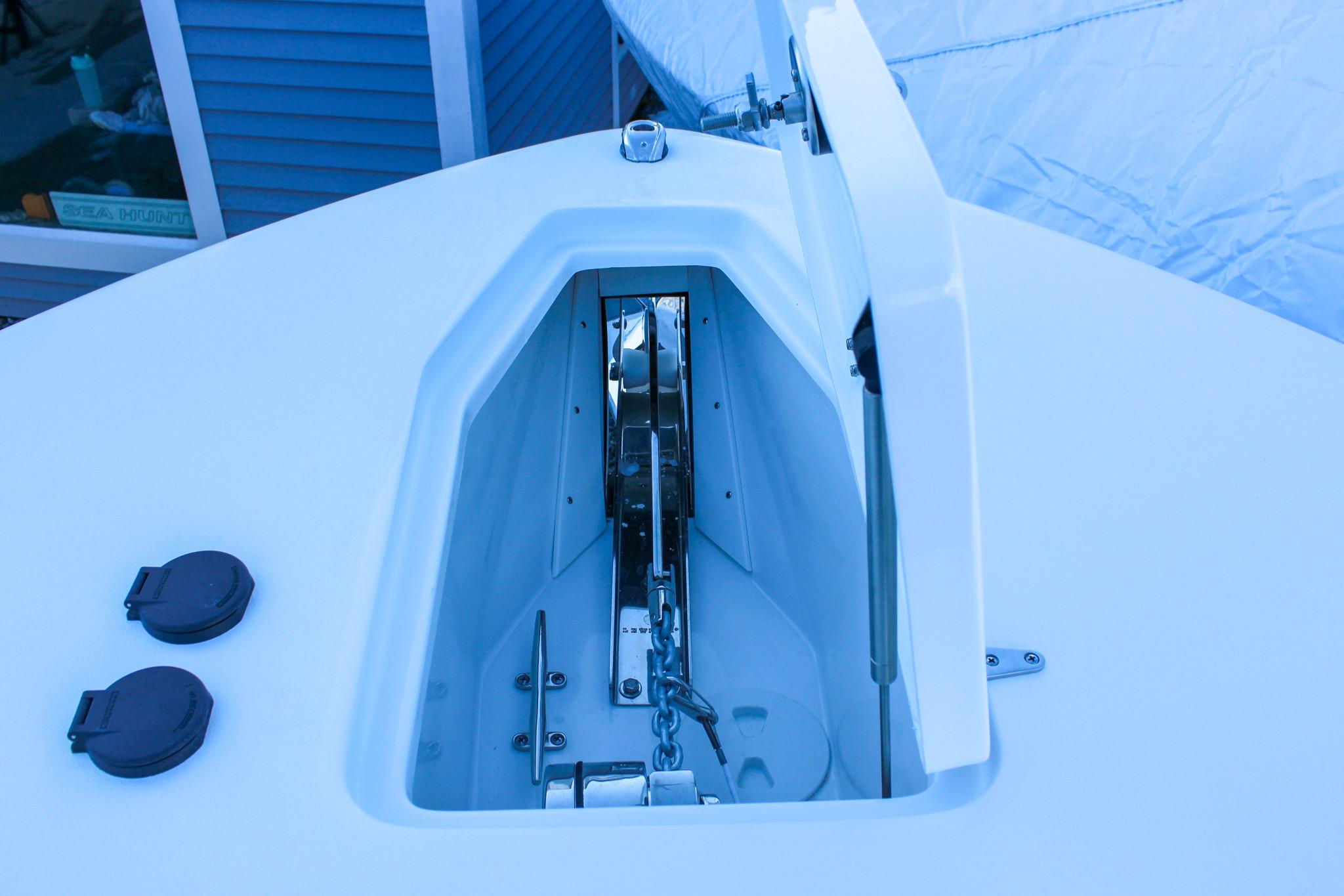 Anchor compartment of 2026 Sea Hunt Gamefish 25 boat, open with visible chain.