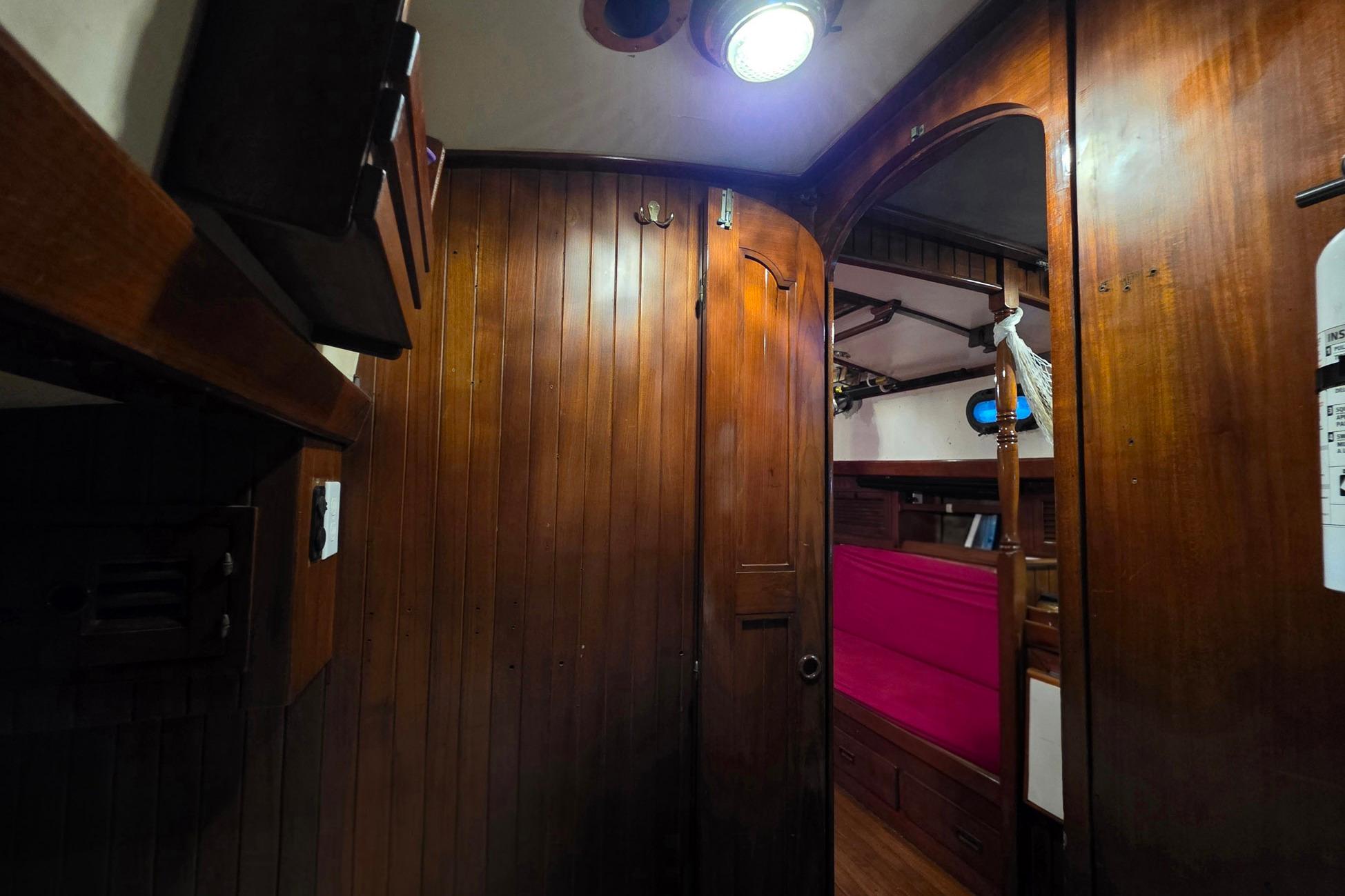 Interior of 1982 Tayana 37 sailboat with wooden paneling and cozy cabin space.