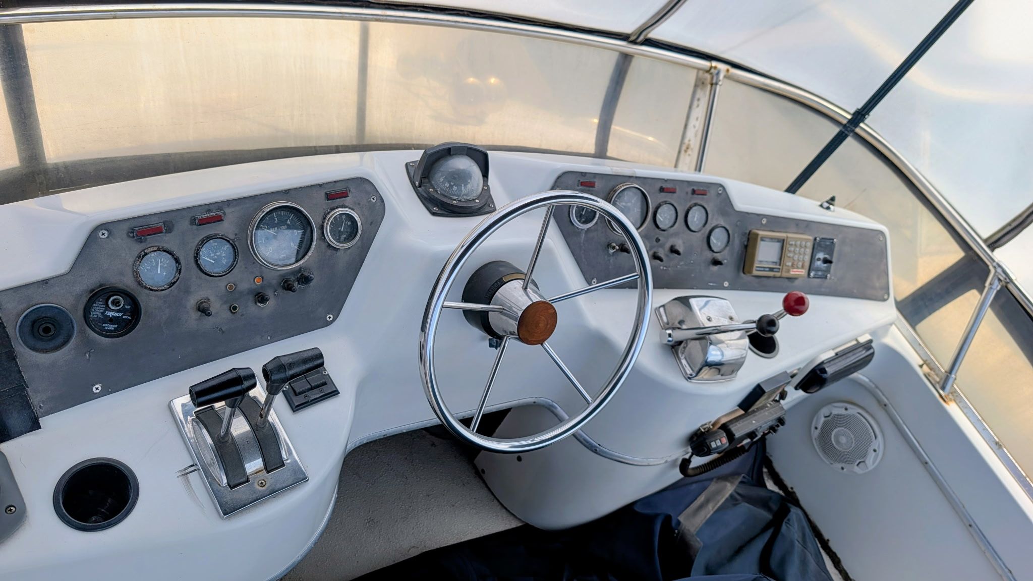 The image shows the helm of a 1987 Chris-Craft 320 Amerosport Express with various instruments.