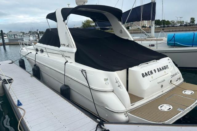 Sea Ray Sundancer 310 yacht docked, covered, 2000 model, marina background.