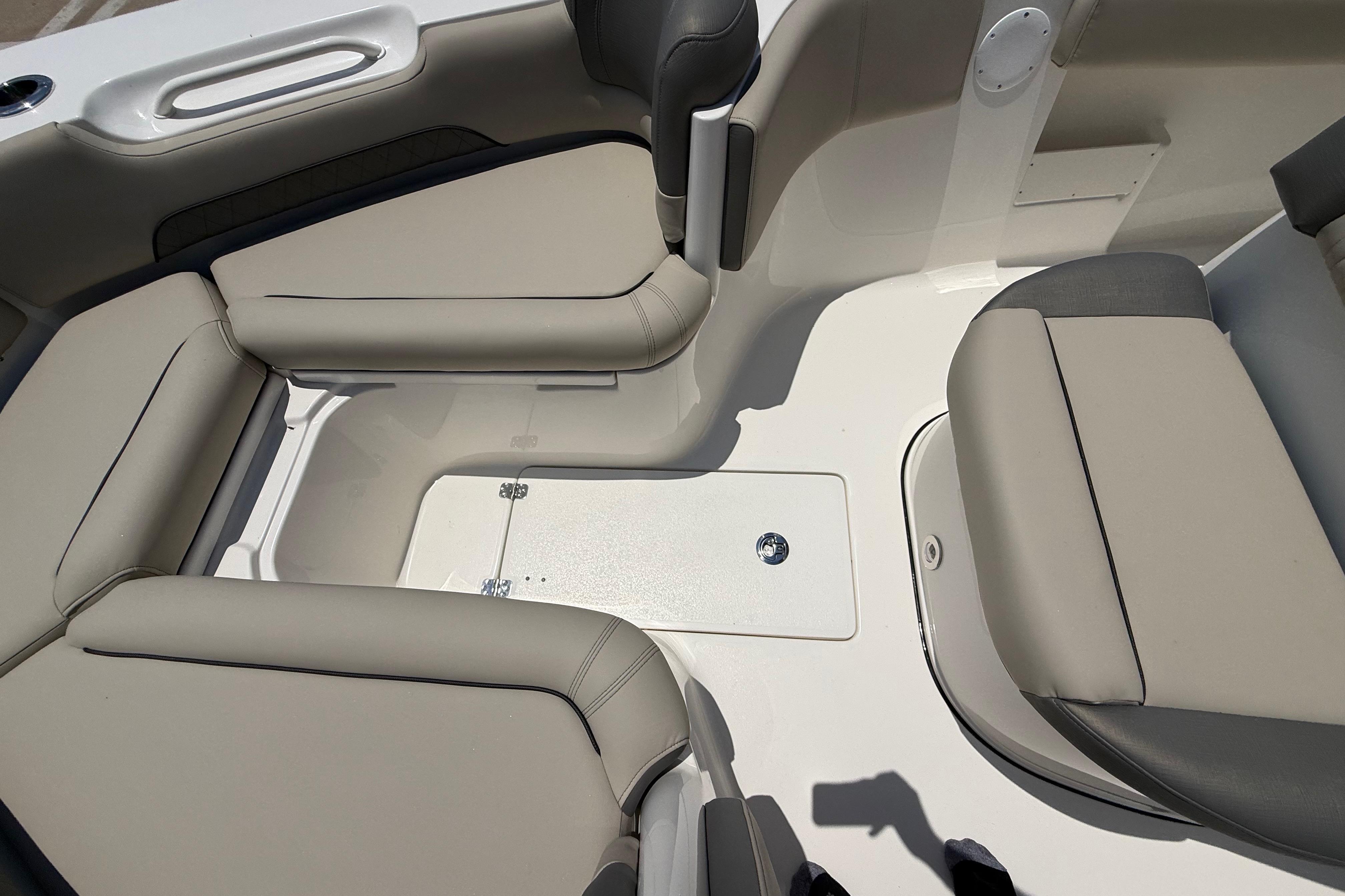 Interior seating of 2027 Key West 249 FS boat, featuring beige and gray cushioned seats.