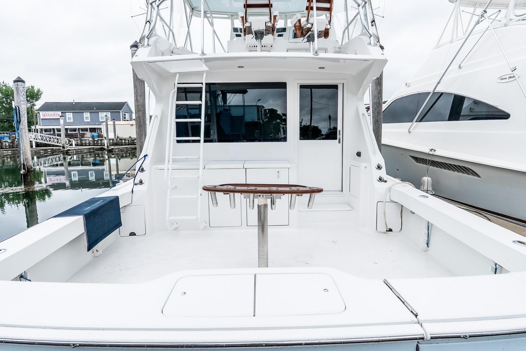 2000 Viking 50' Convertible yacht docked, featuring spacious deck and sleek design.