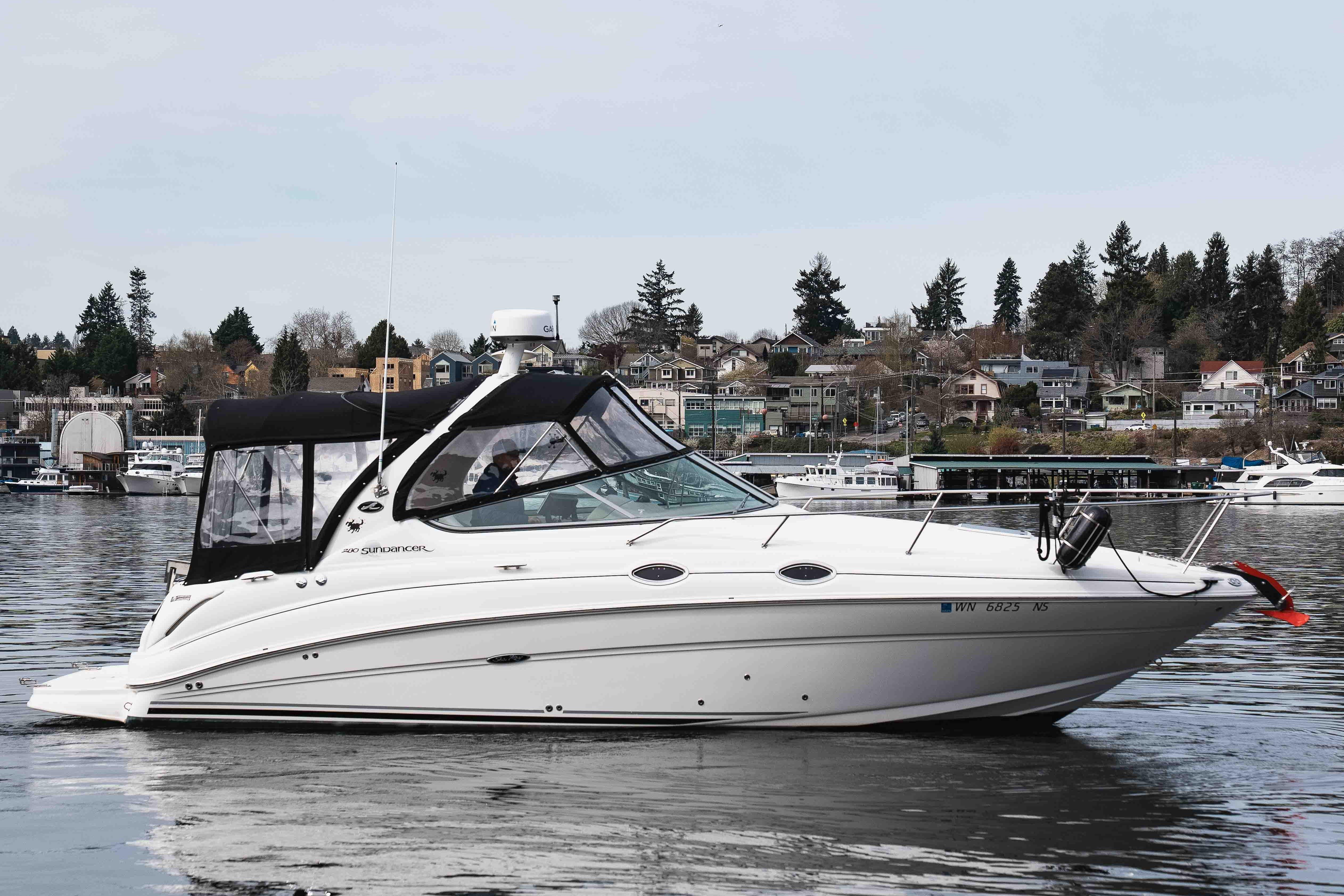 2006 Sea Ray Sundancer 280 boat on calm water with scenic background.