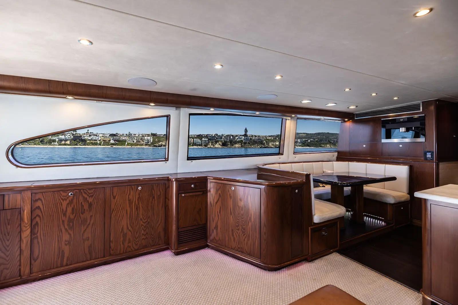 Luxurious interior of 1993 Lydia Sportfisher yacht with elegant wood finishes and scenic windows.