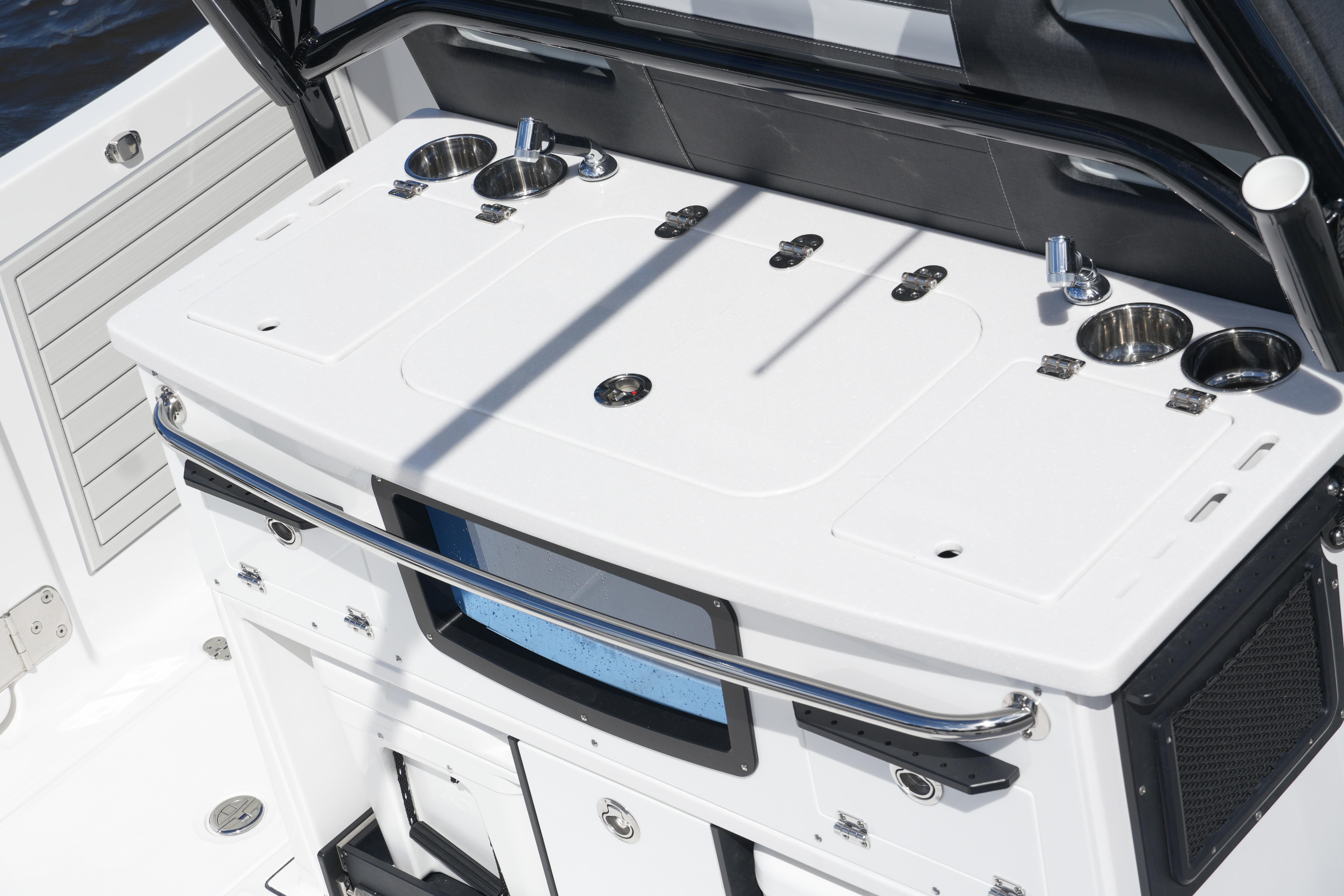 2026 Blackfin 332 CC boat console with cup holders and storage compartments.