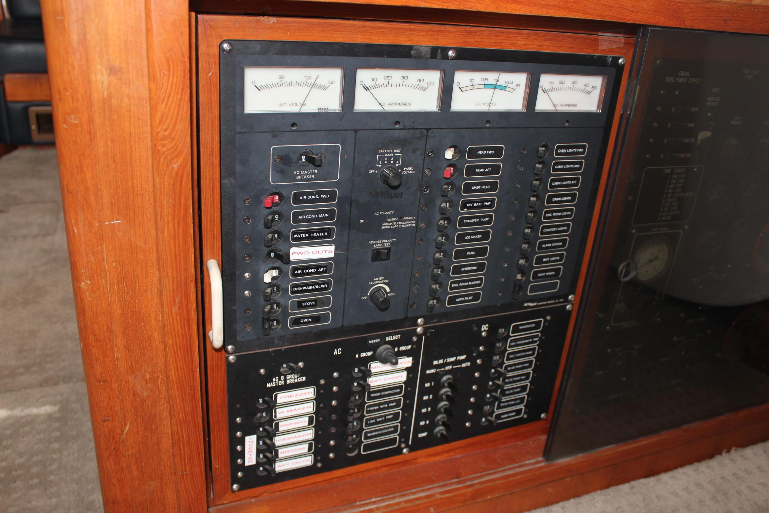Electrical control panel on a 1994 Mikelson 64 yacht, featuring gauges and switches.