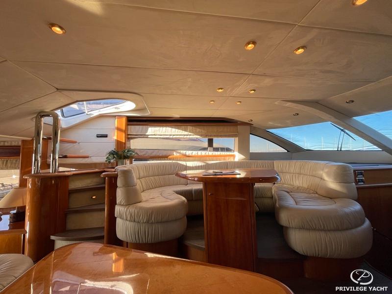 Luxurious interior of 2001 Sunseeker Manhattan 74 yacht with elegant seating and wood finishes.