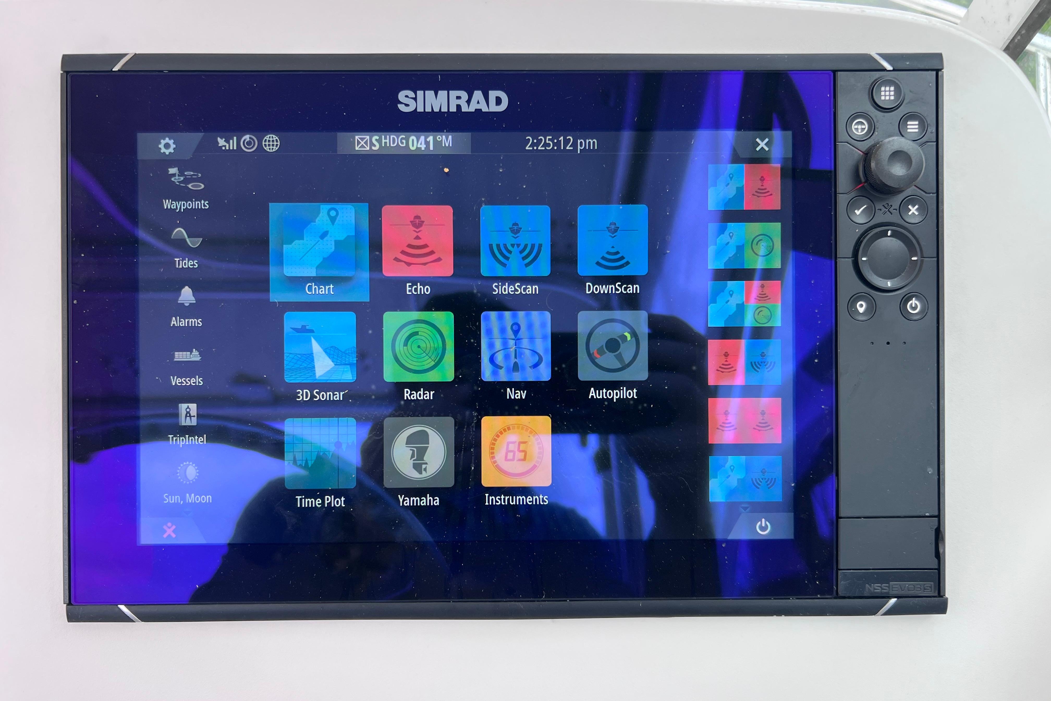 Simrad marine display on 2005 Pursuit 3070 Offshore, showing navigation and sonar options.