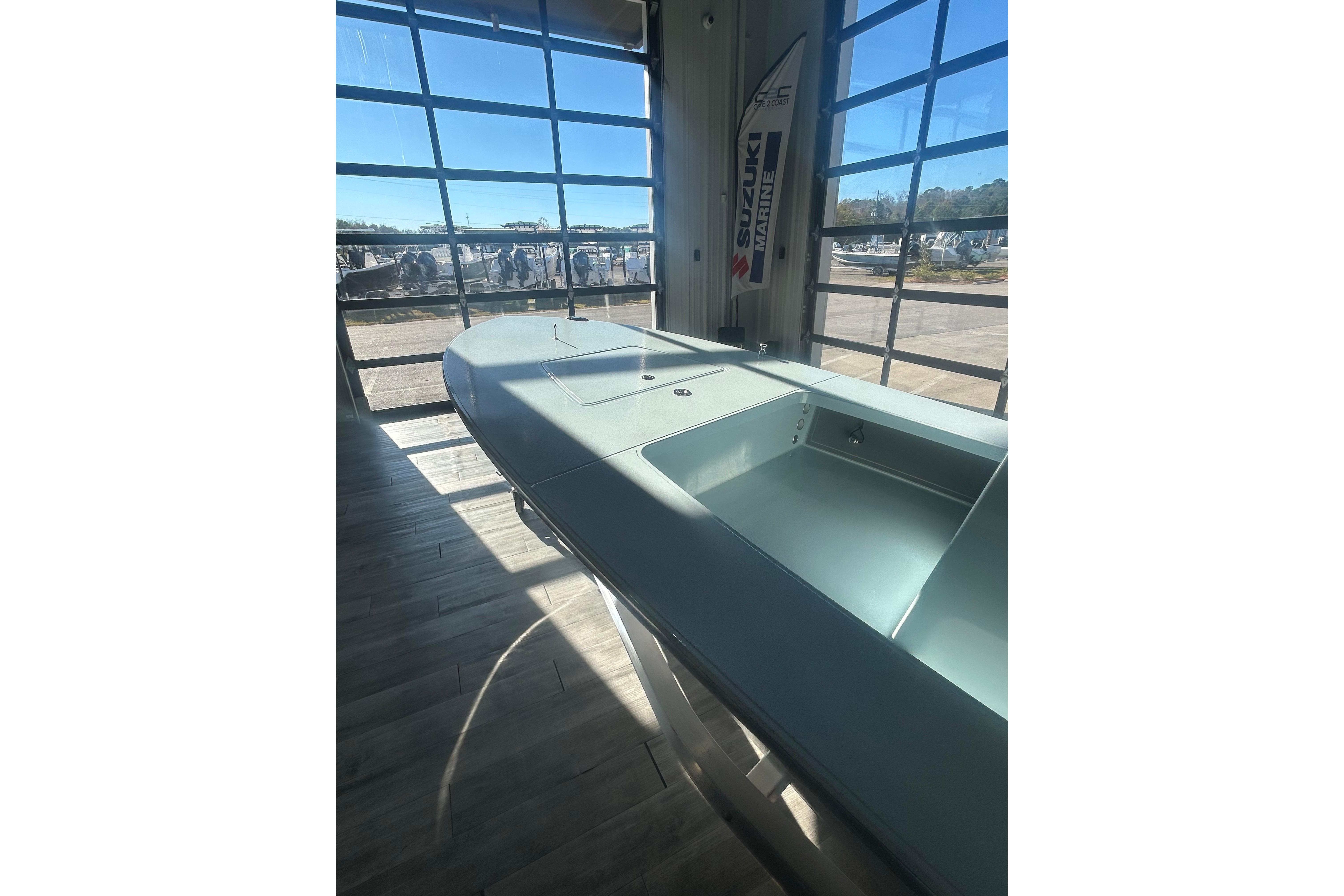 2026 East Cape Evo 17X boat displayed indoors with sunlight streaming through large windows.