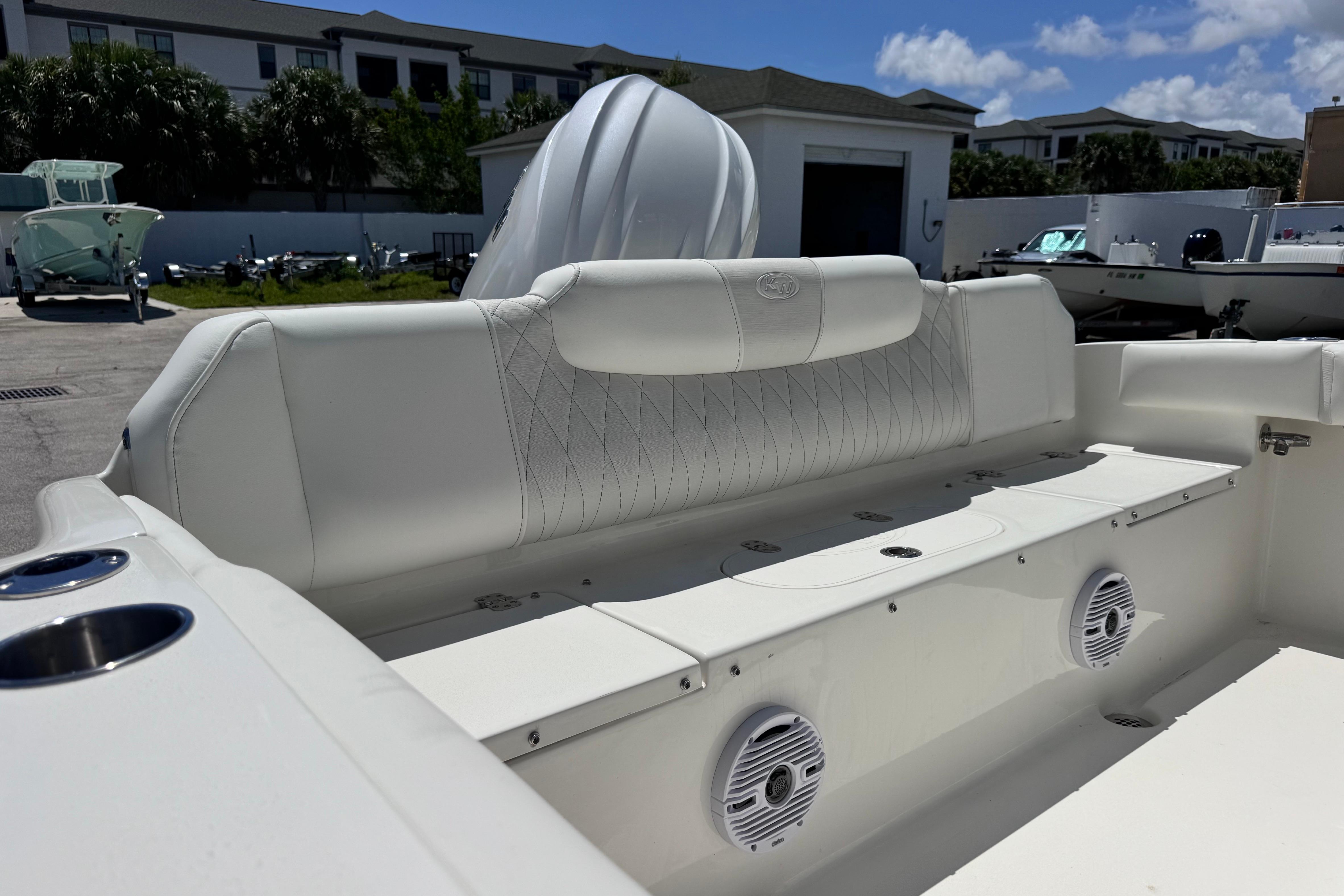 2026 Key West 219 FS boat interior with white seating and speakers.