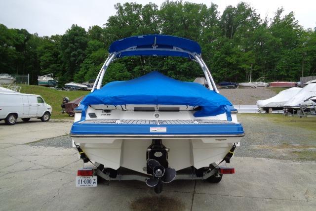2019 Monterey 218SS Super Sport boat with blue cover, parked outdoors.