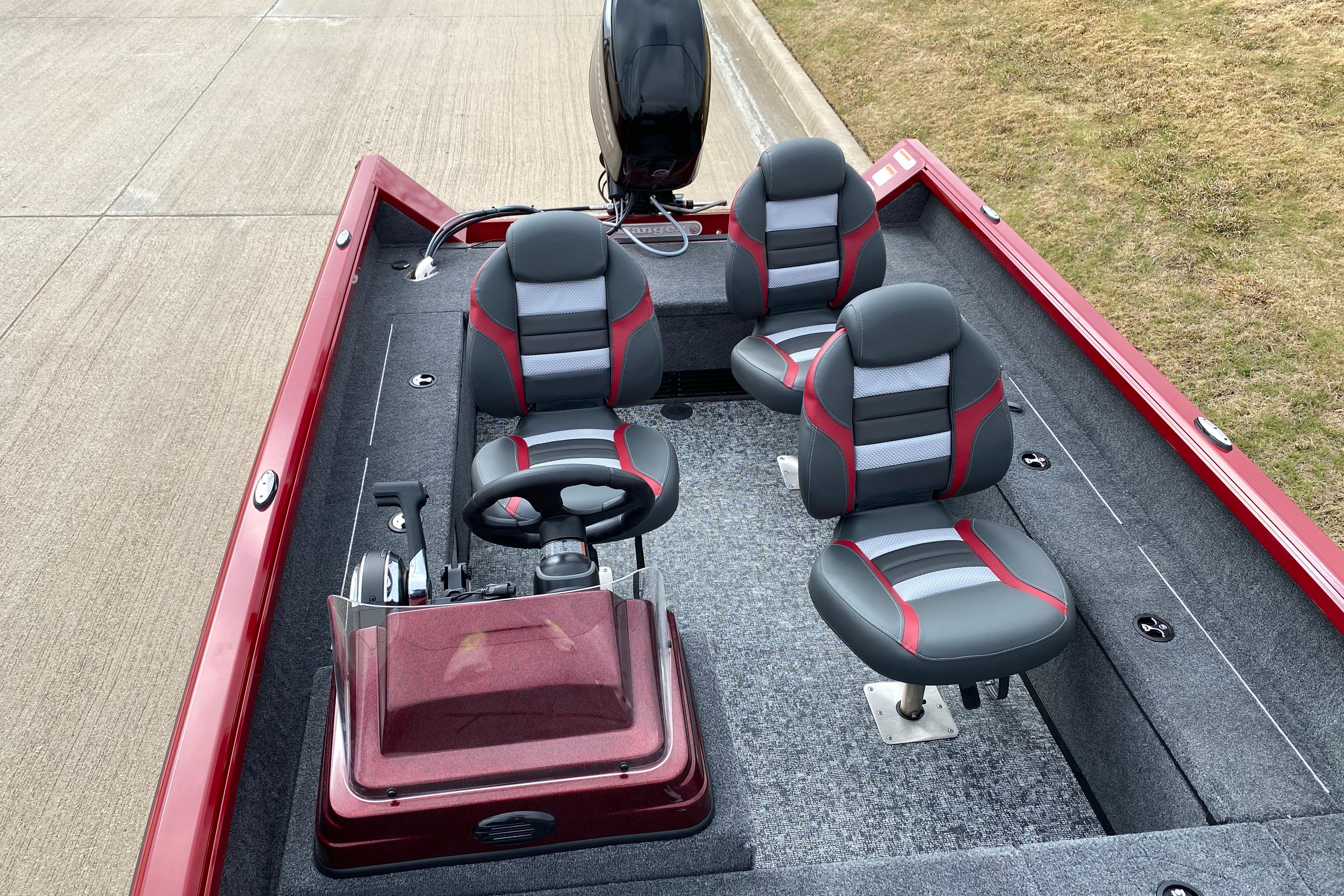 2026 Ranger VS1665SC boat with red and gray seating, steering console, and motor.