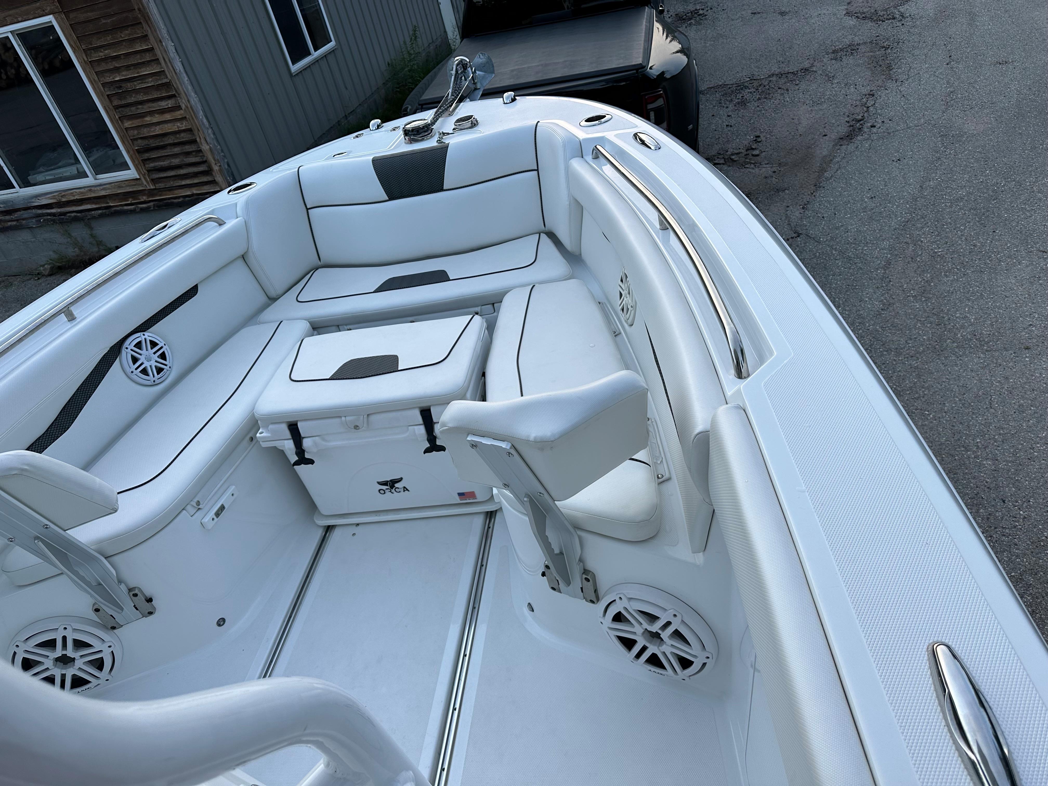 2021 Wellcraft 262 Fisherman boat interior with white seating and storage compartments.