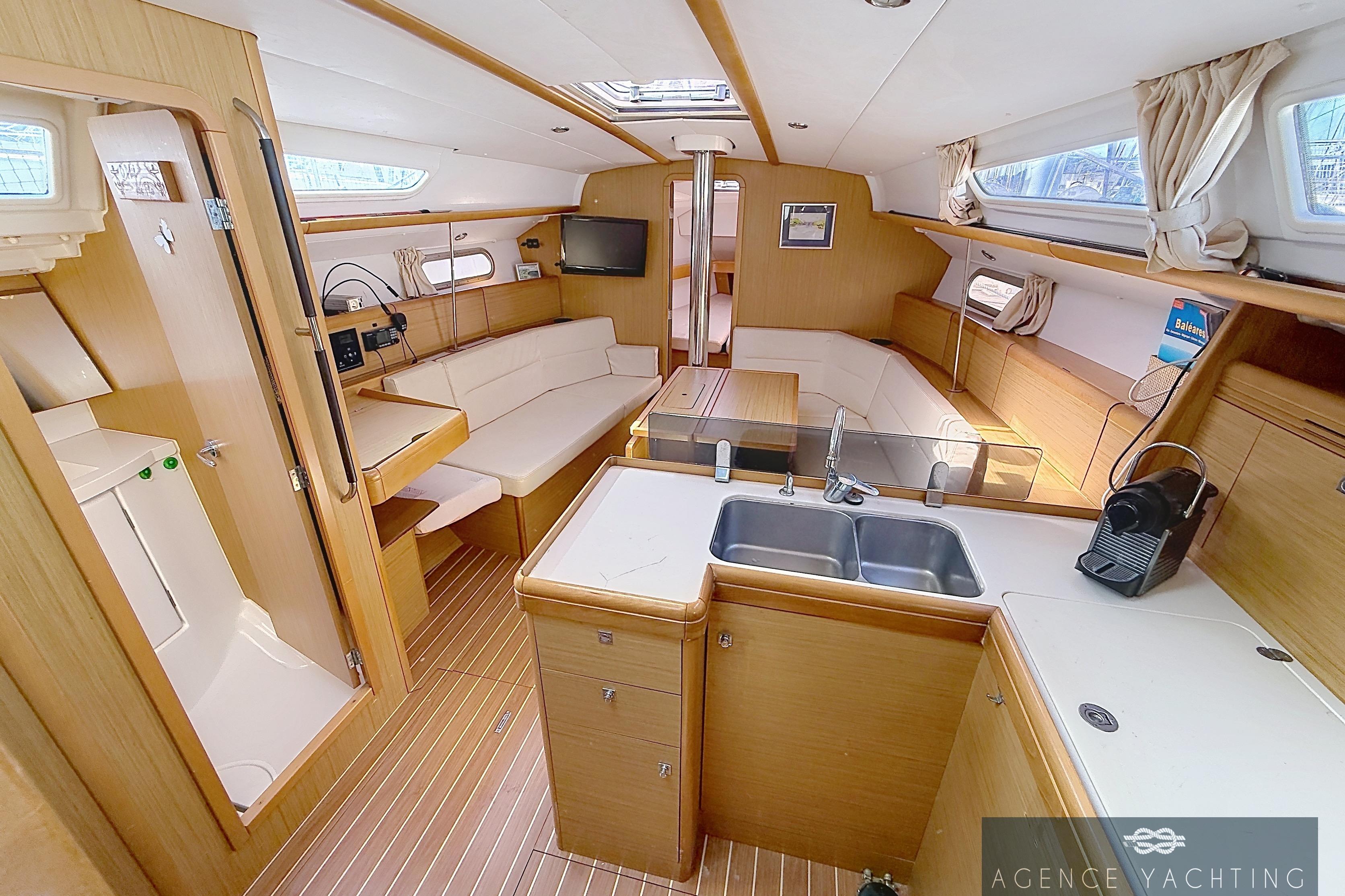 Interior of 2009 Jeanneau Sun Odyssey 39i Performance yacht, featuring modern kitchen and seating area.