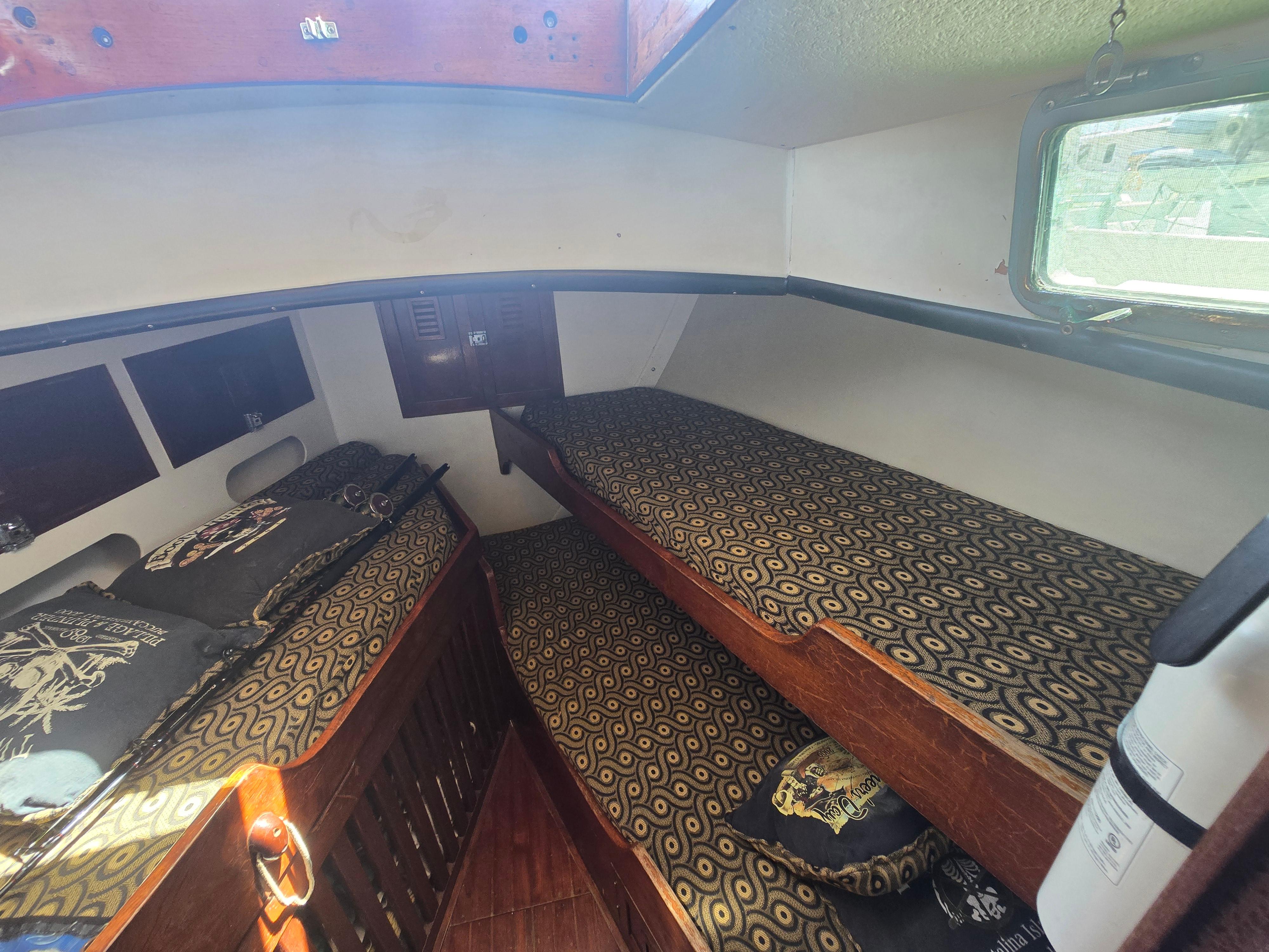 Interior of a 1978 Herreshoff 50 sailboat with patterned bunk beds.