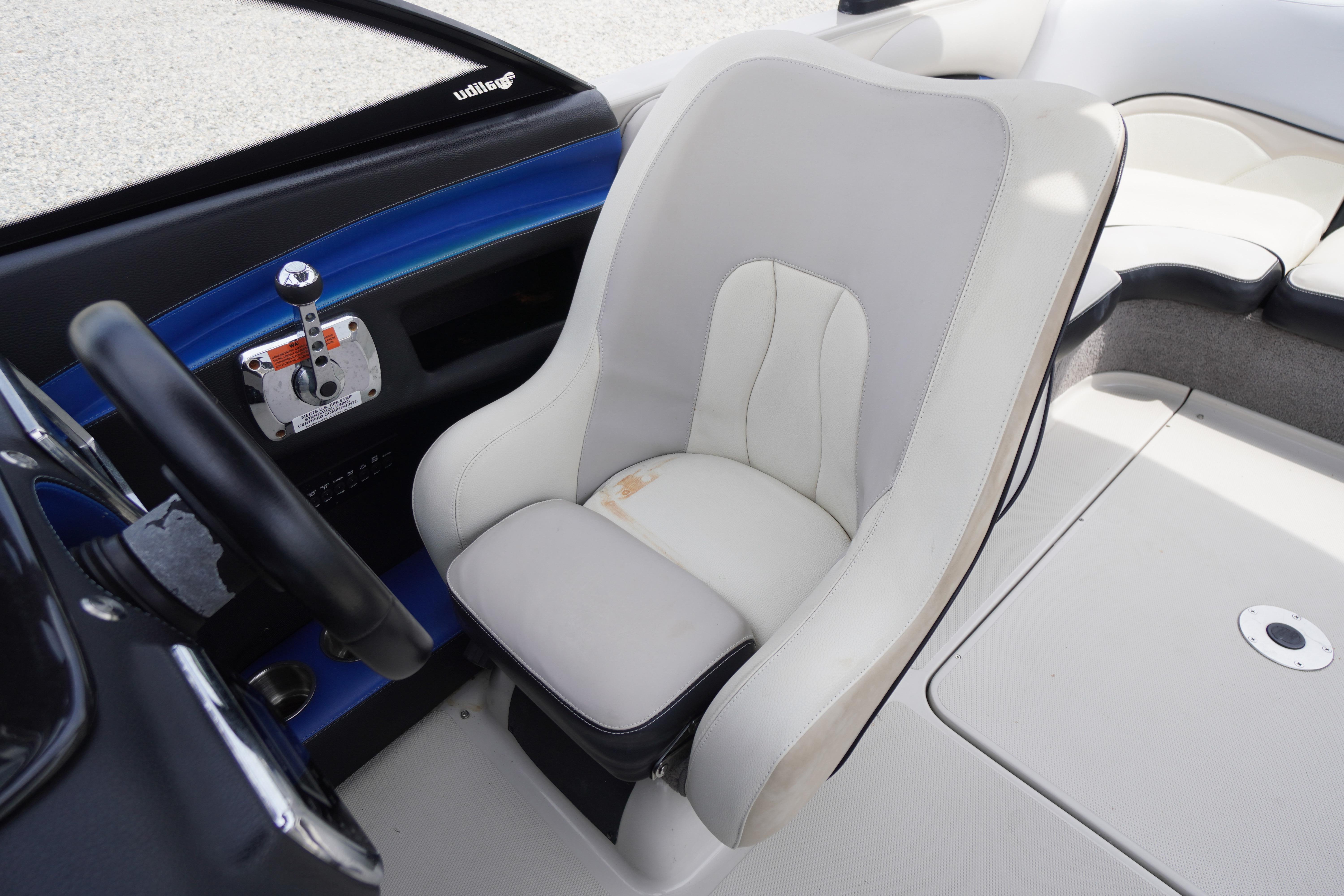 Captain's seat in 2011 Malibu Wakesetter 21 VLX boat, featuring sleek design and controls.