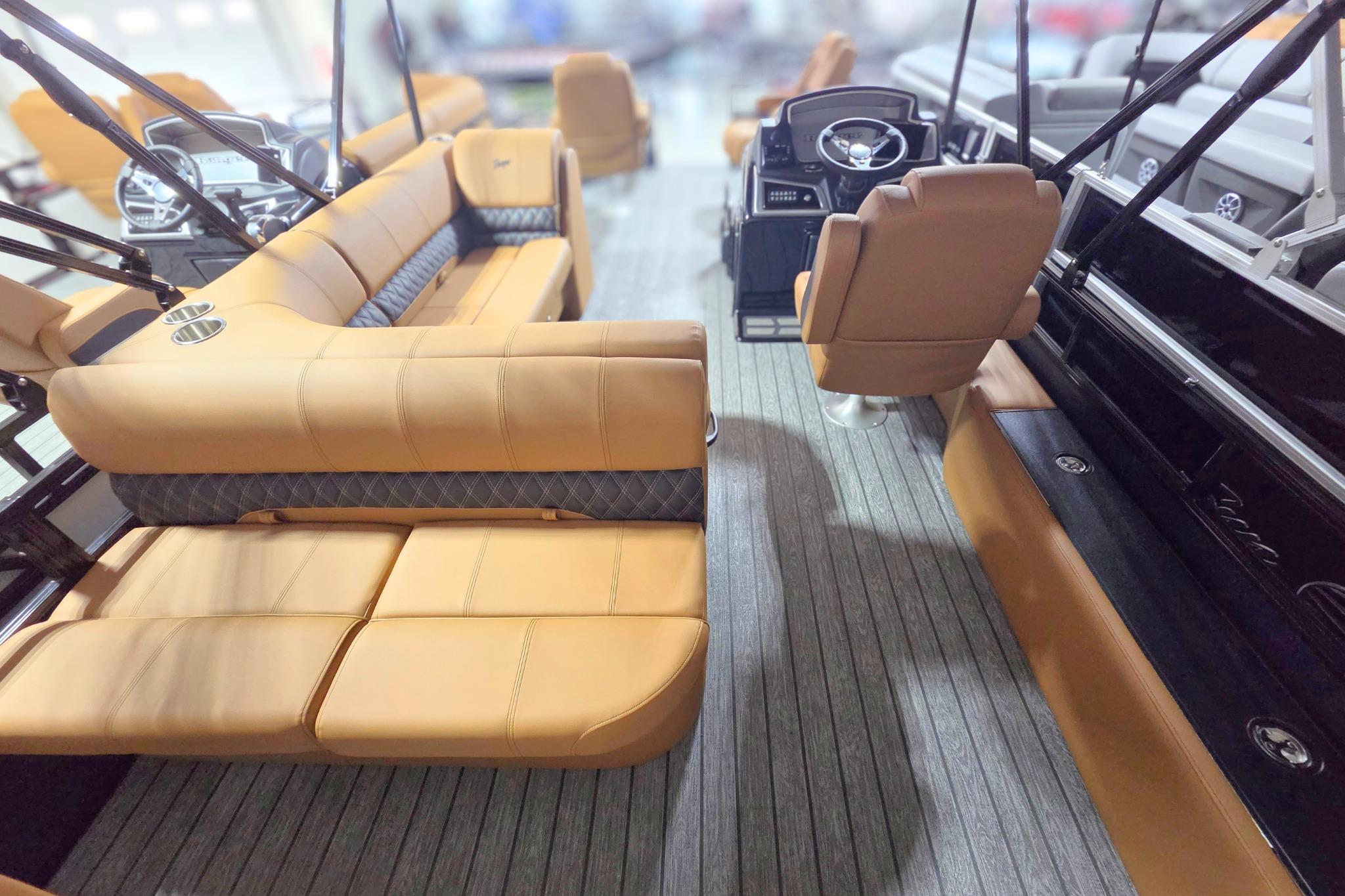 2026 Ranger 220F boat interior with tan leather seating and modern steering console.