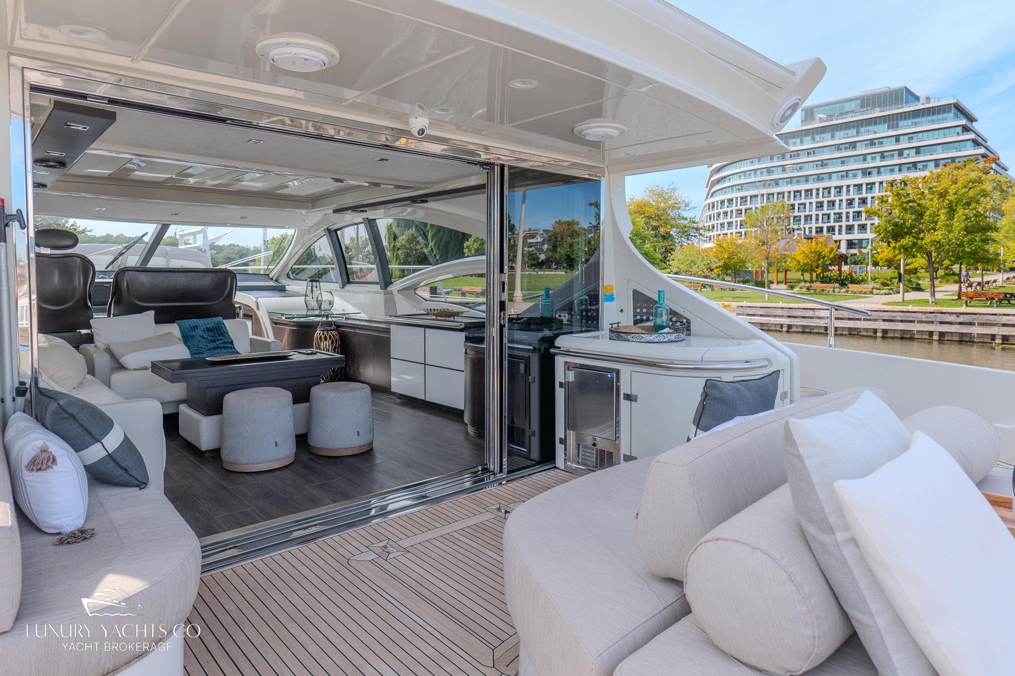 Luxurious 2010 Azimut 62S yacht interior with modern seating and scenic waterfront view.