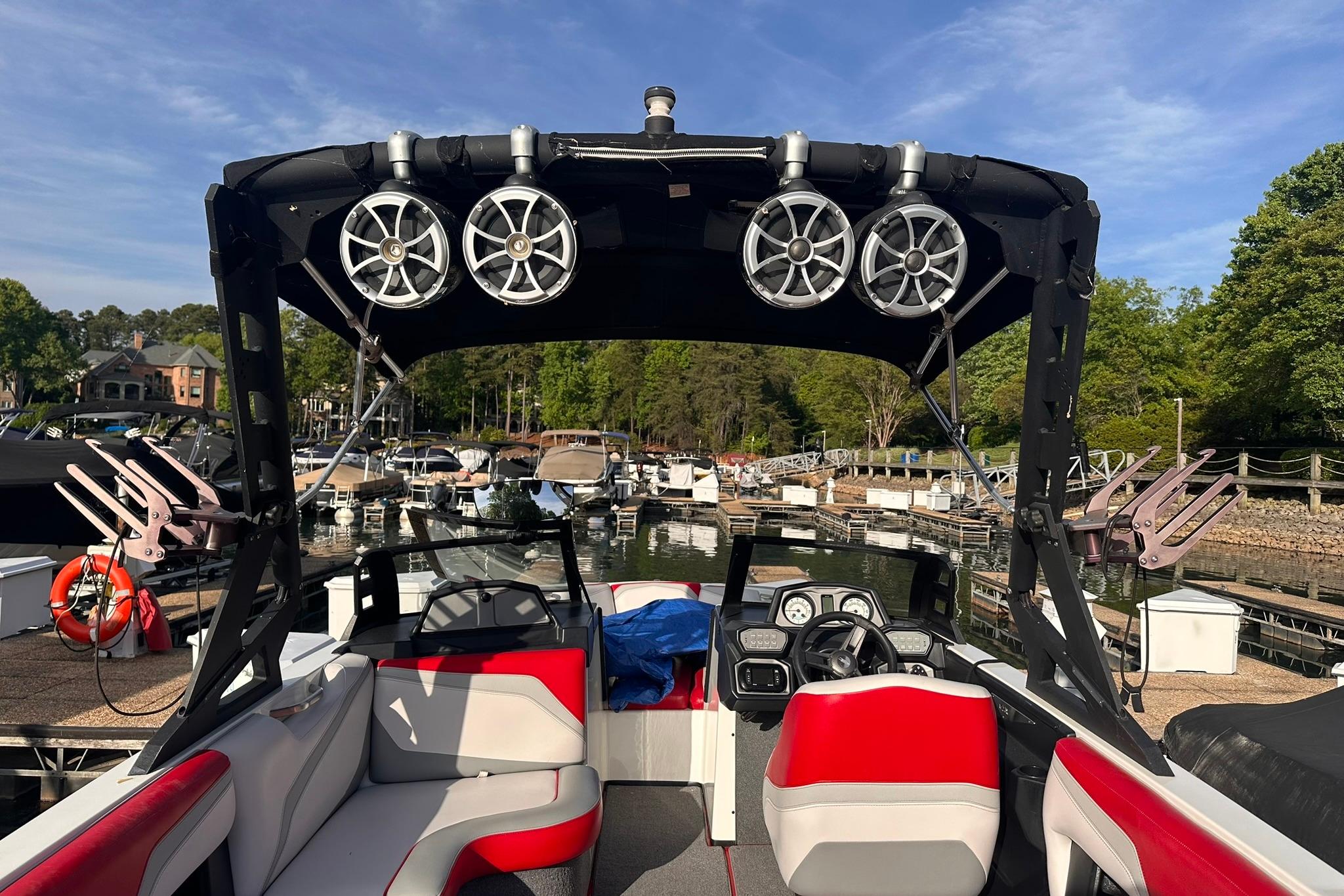 2017 Axis T23 boat interior with red and gray seating, docked at a marina.