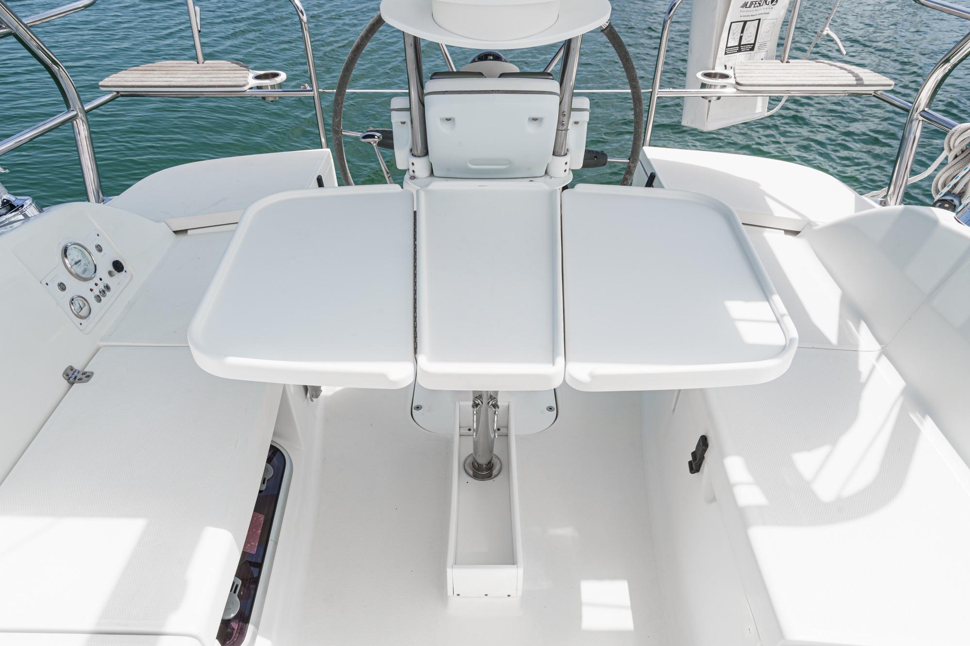Cockpit of 2015 Hunter 33 sailboat with foldable table and seating.