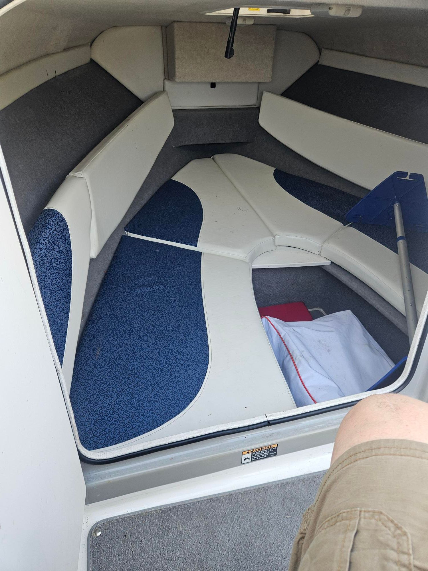 Interior of a 2006 Bayliner Cuddy Cab with blue cushions.