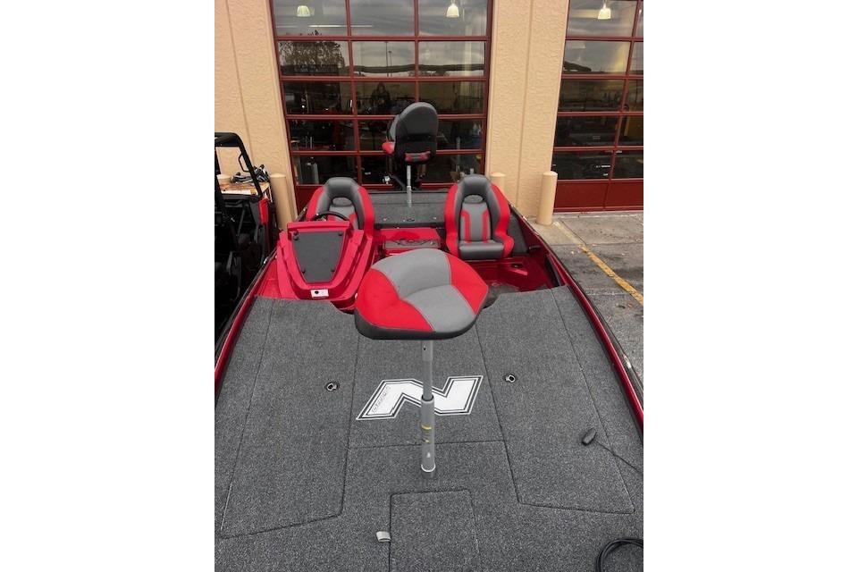 2025 Nitro Z20 XL Pro boat with red and gray seating, displayed outdoors.