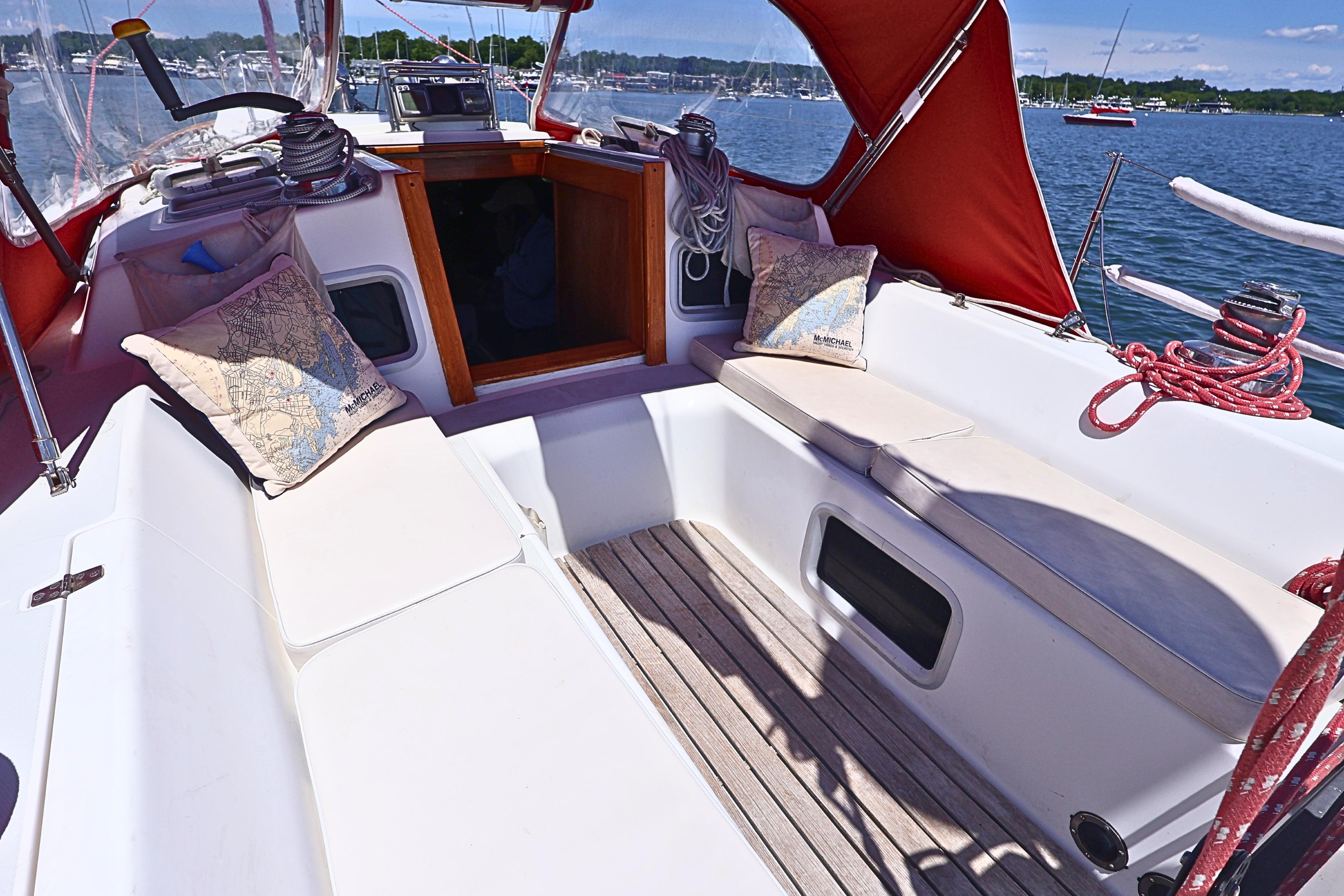 Cockpit of 1989 J Boat J 40 sailboat with red canopy and comfortable seating.