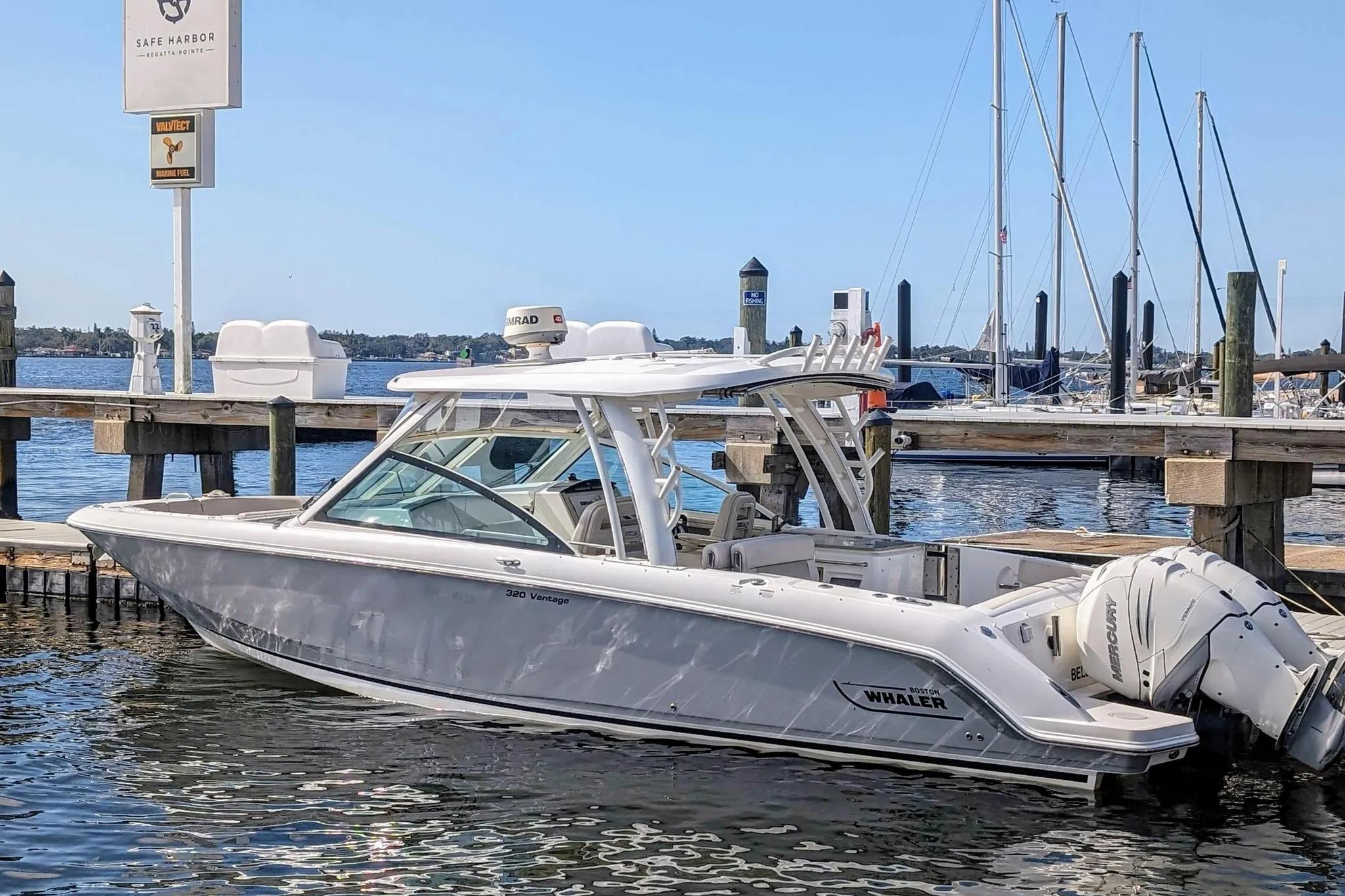 2017 Boston Whaler 320 Vantage docked at marina with clear blue sky.