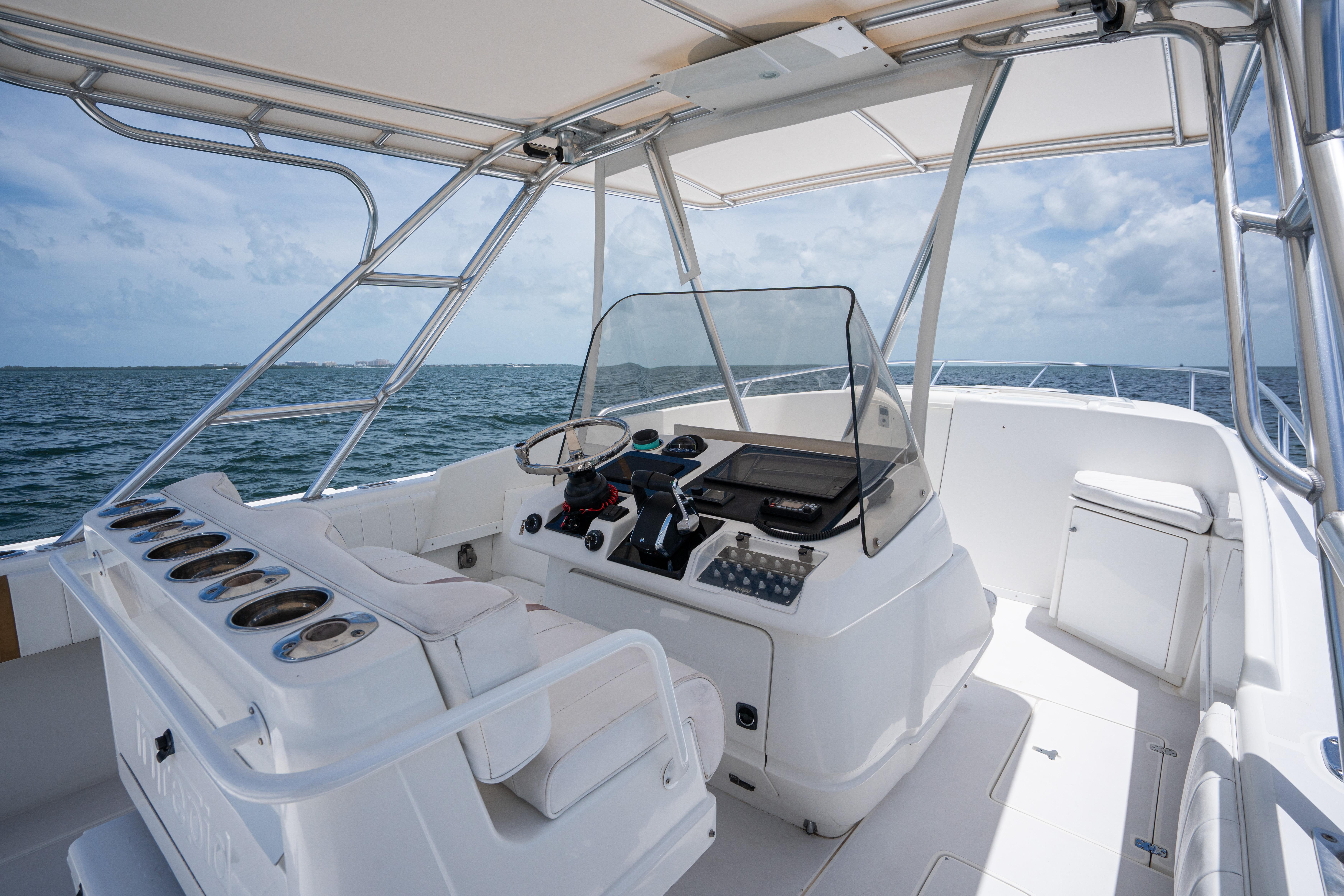 1999 Intrepid 35 boat interior with helm, ocean view, and clear sky.
