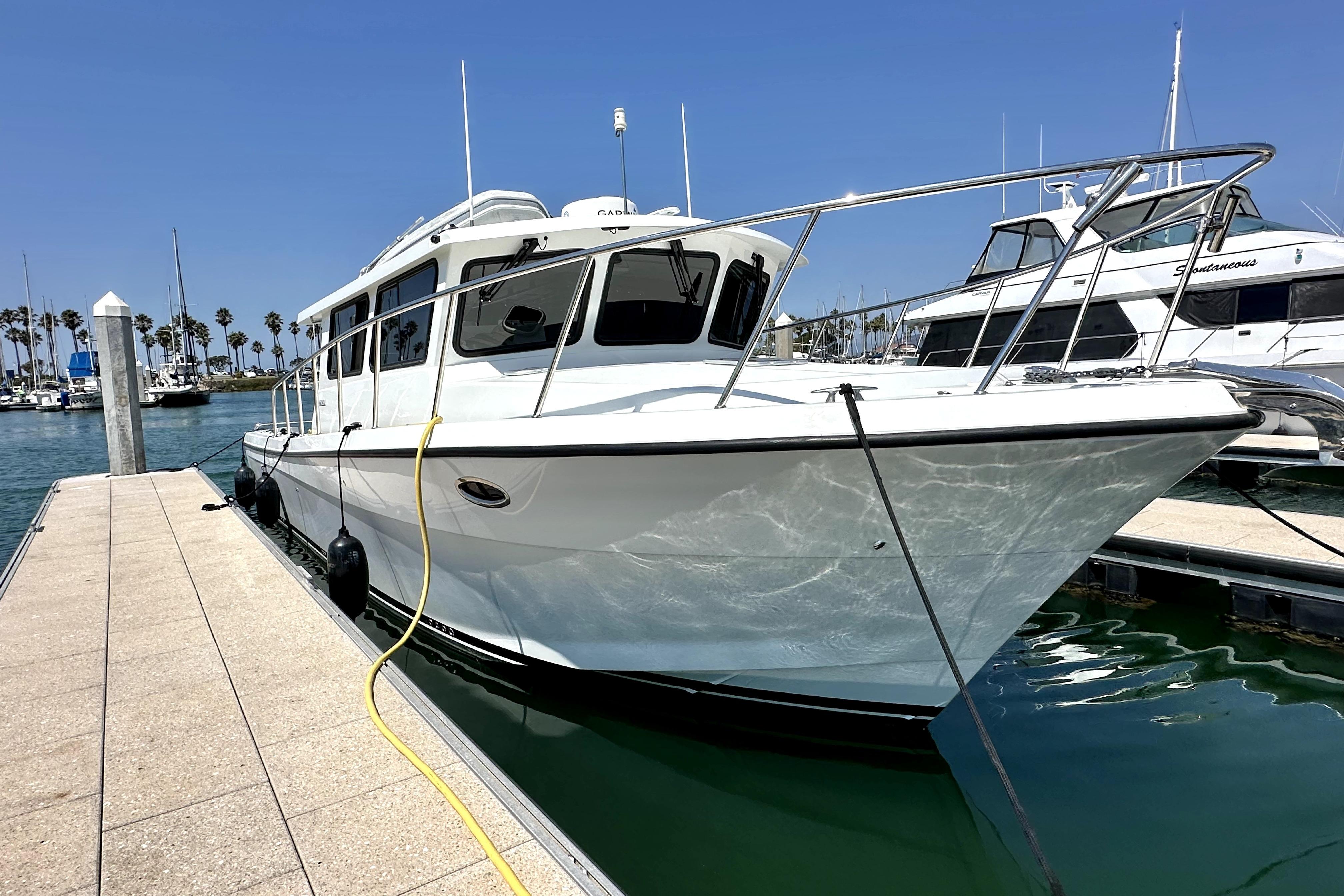 2021 Lindell 42/46 boat docked at marina under clear blue sky.