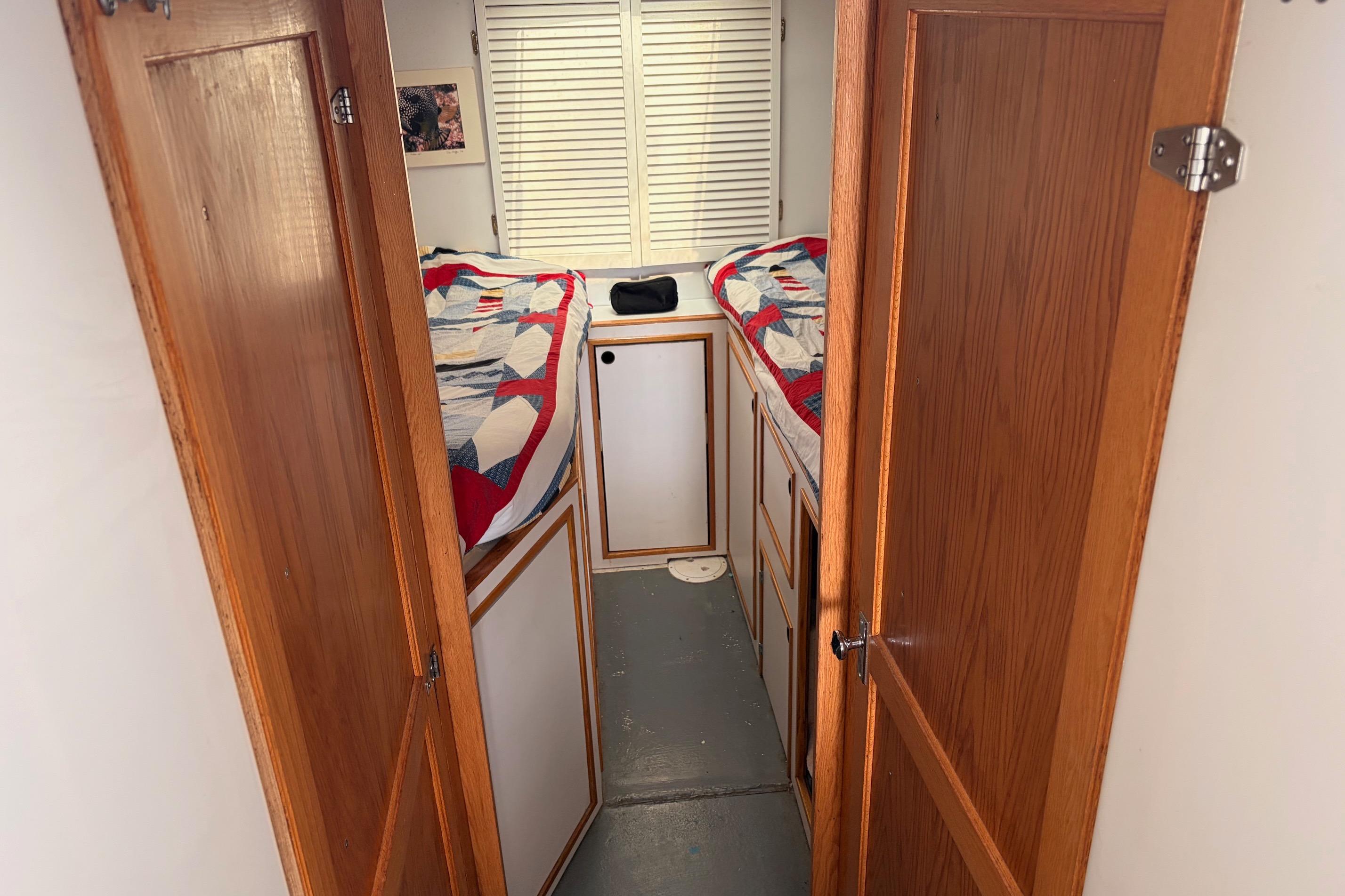 Interior of 2000 Provincial 42 Pleasure Boat with twin beds and wooden doors.