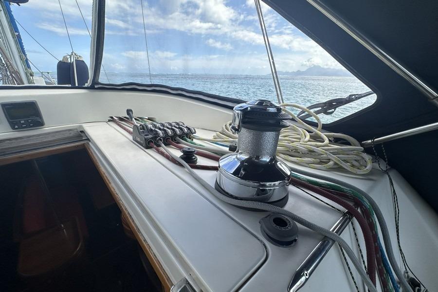 Cockpit view of 2010 Allures 44 sailboat with winch and ropes, ocean in background.