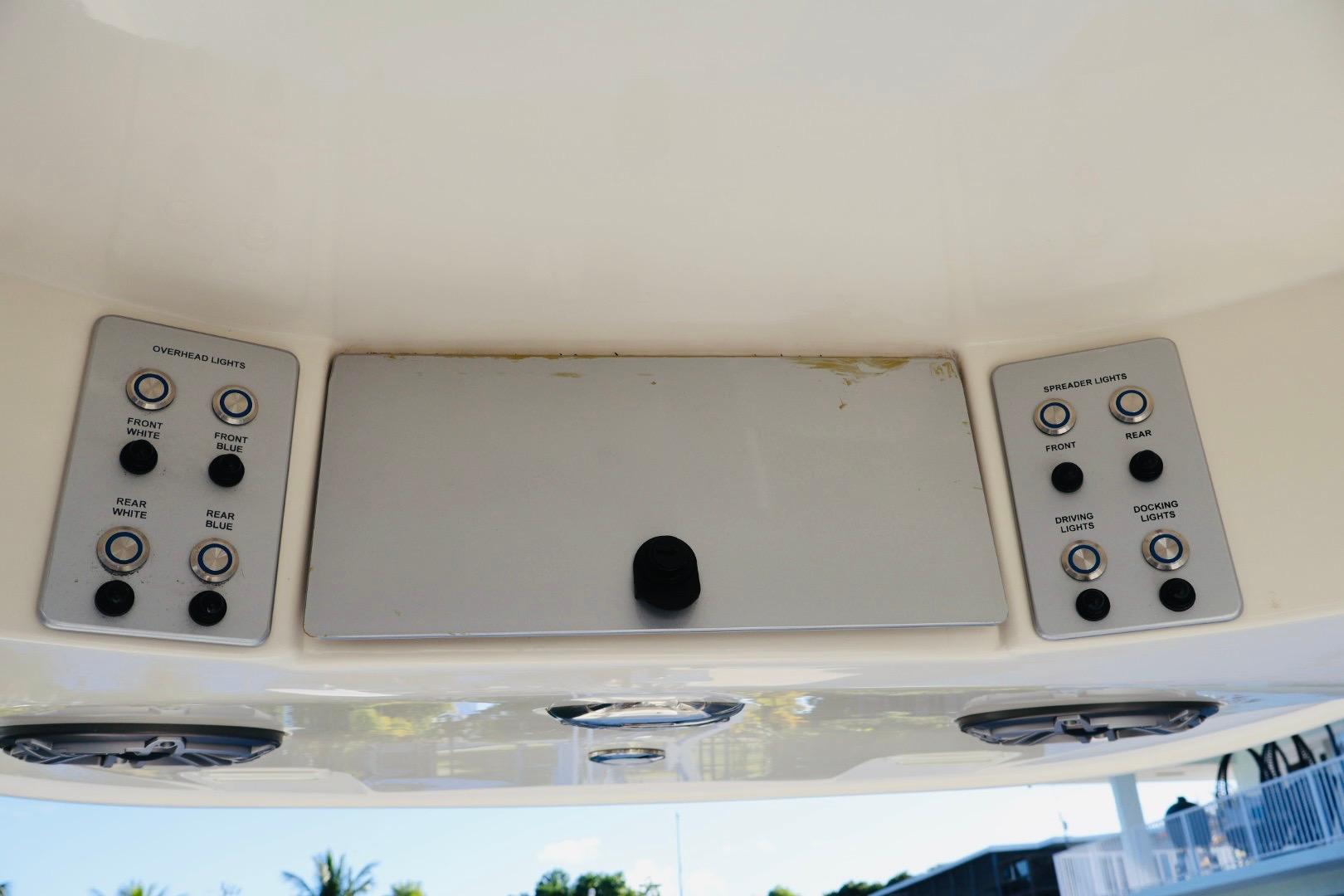 Control panel of 2022 ShearWater 23LTZ boat with overhead and spreader light switches.