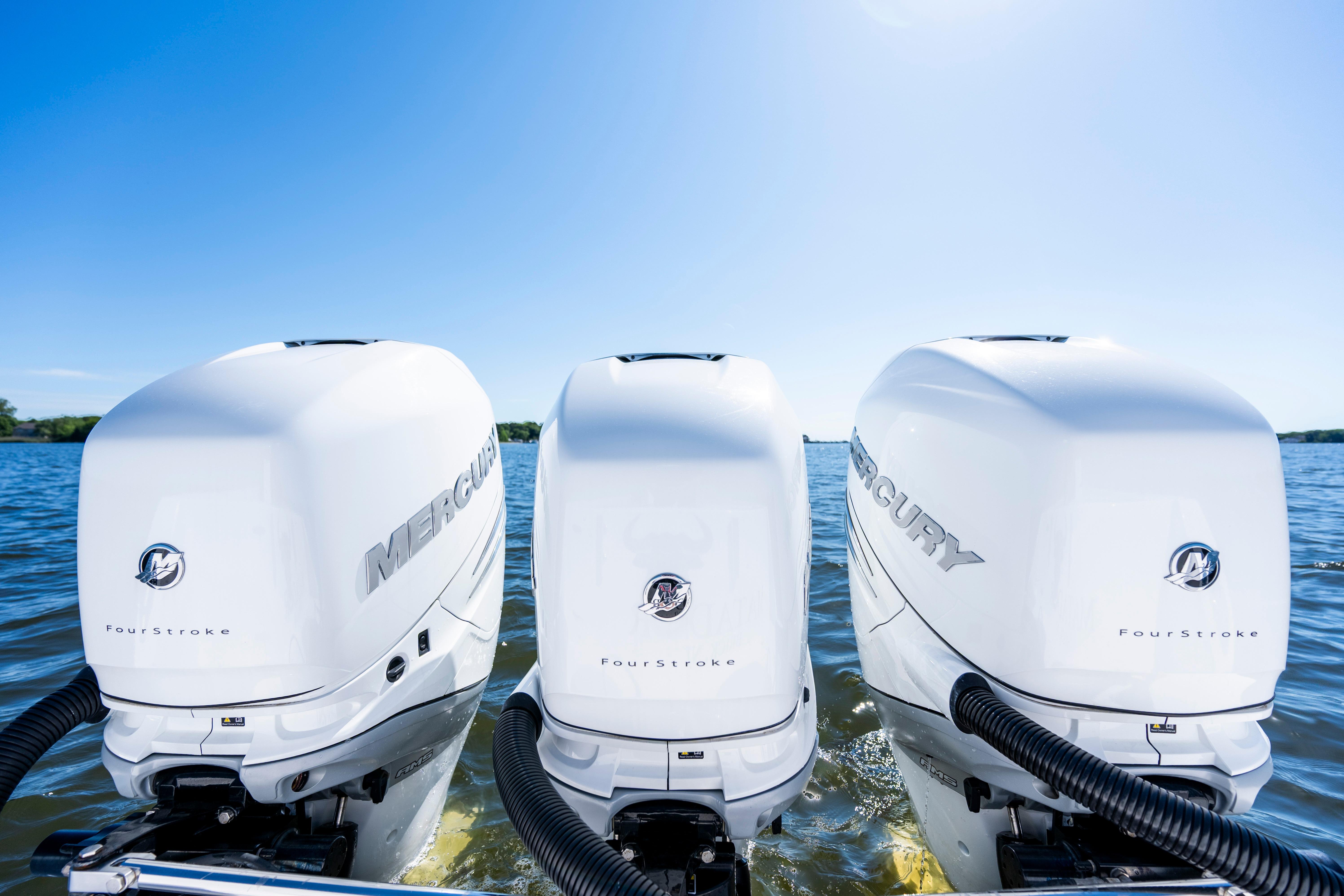 Triple Mercury FourStroke engines on a 2015 Contender 39 ST boat in open water.