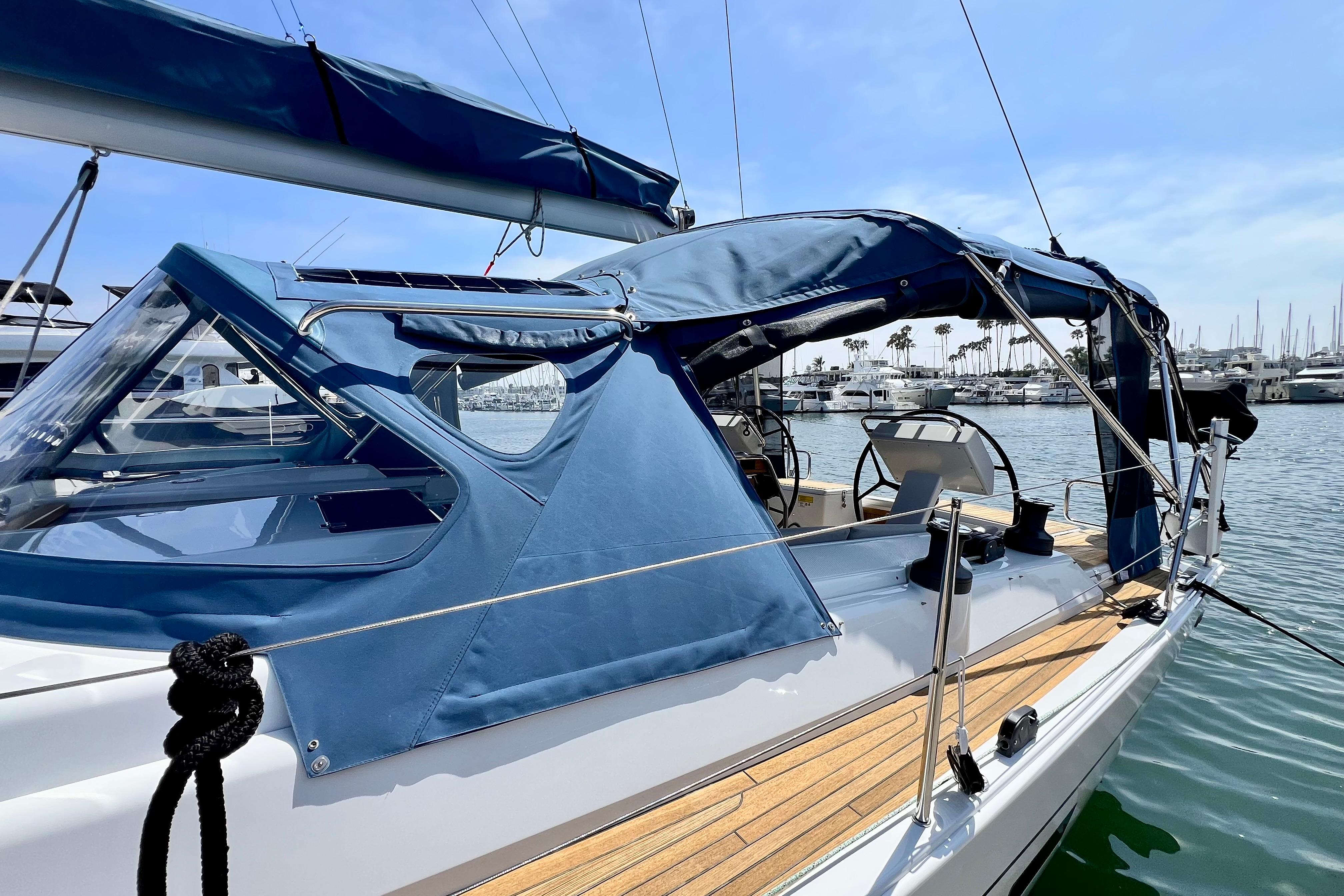 Sailboat Hanse 455 (2016) docked, featuring blue canopy and sleek design.