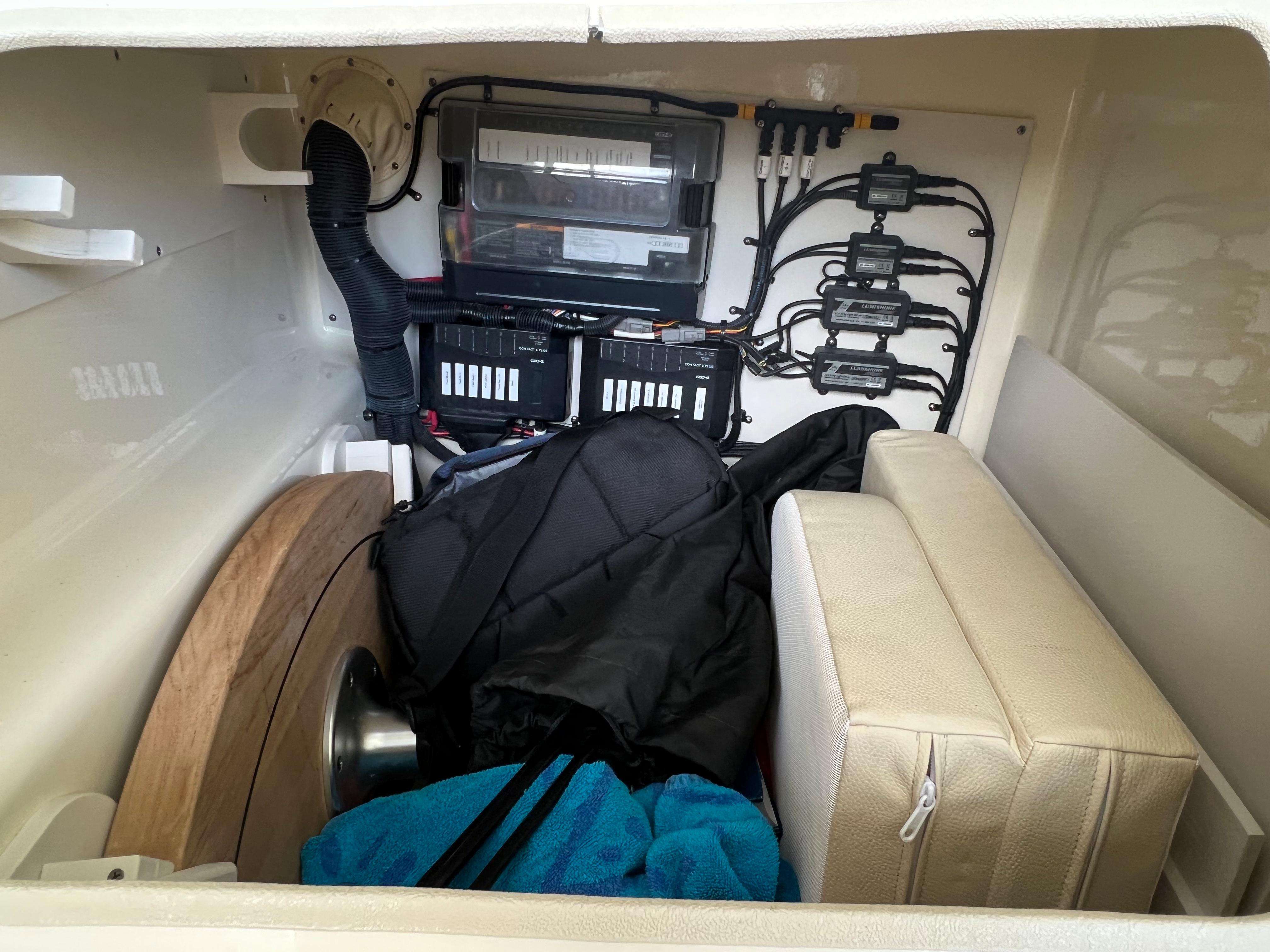 2020 Chris-Craft Launch 31 GT storage compartment with electrical components and gear.