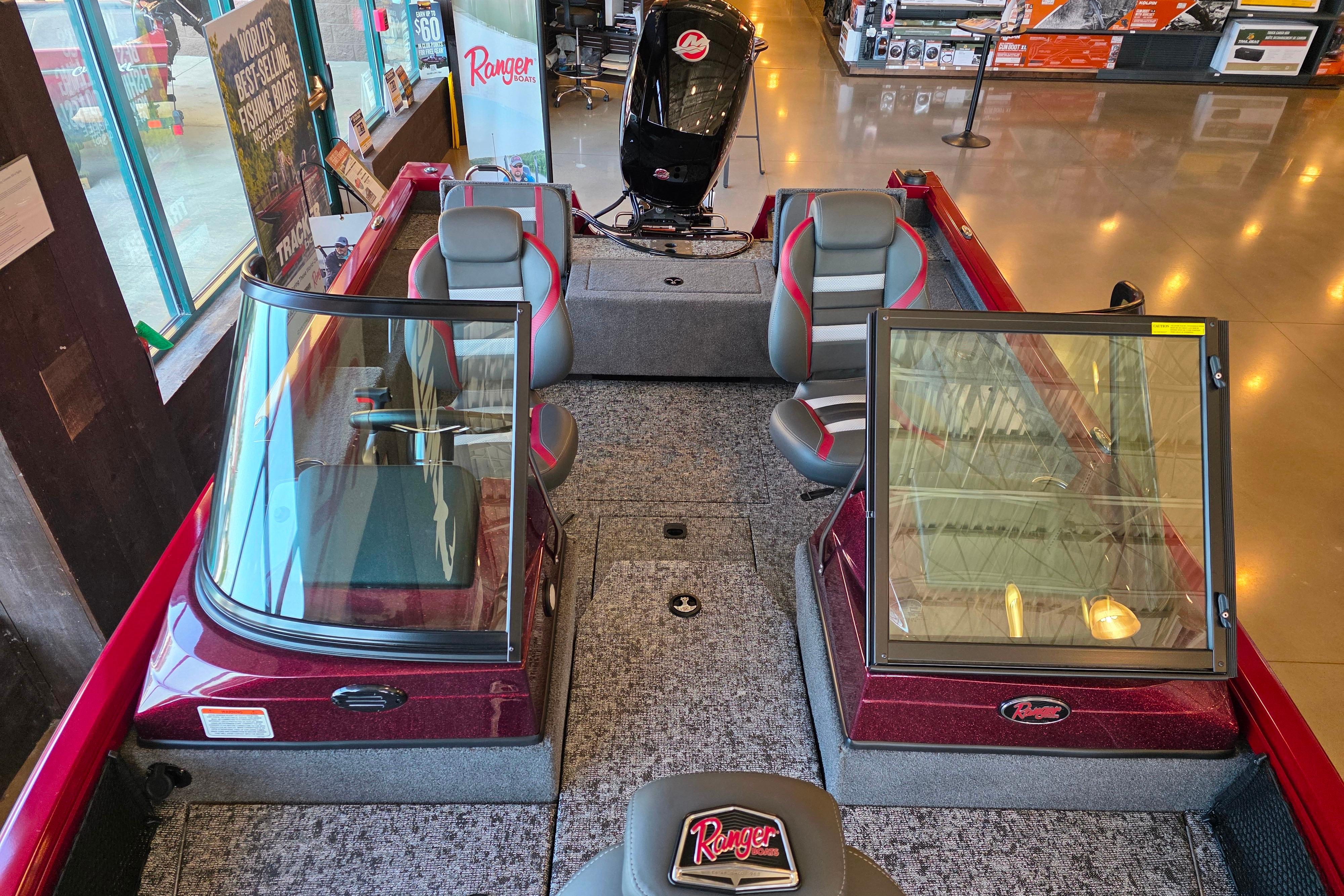 2026 Ranger VS1782SC Reata boat interior with seating and windshield, displayed in showroom.