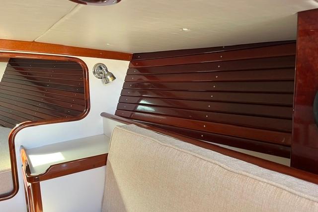Interior of a 2006 Morris 36 boat with polished wood paneling and beige upholstery.
