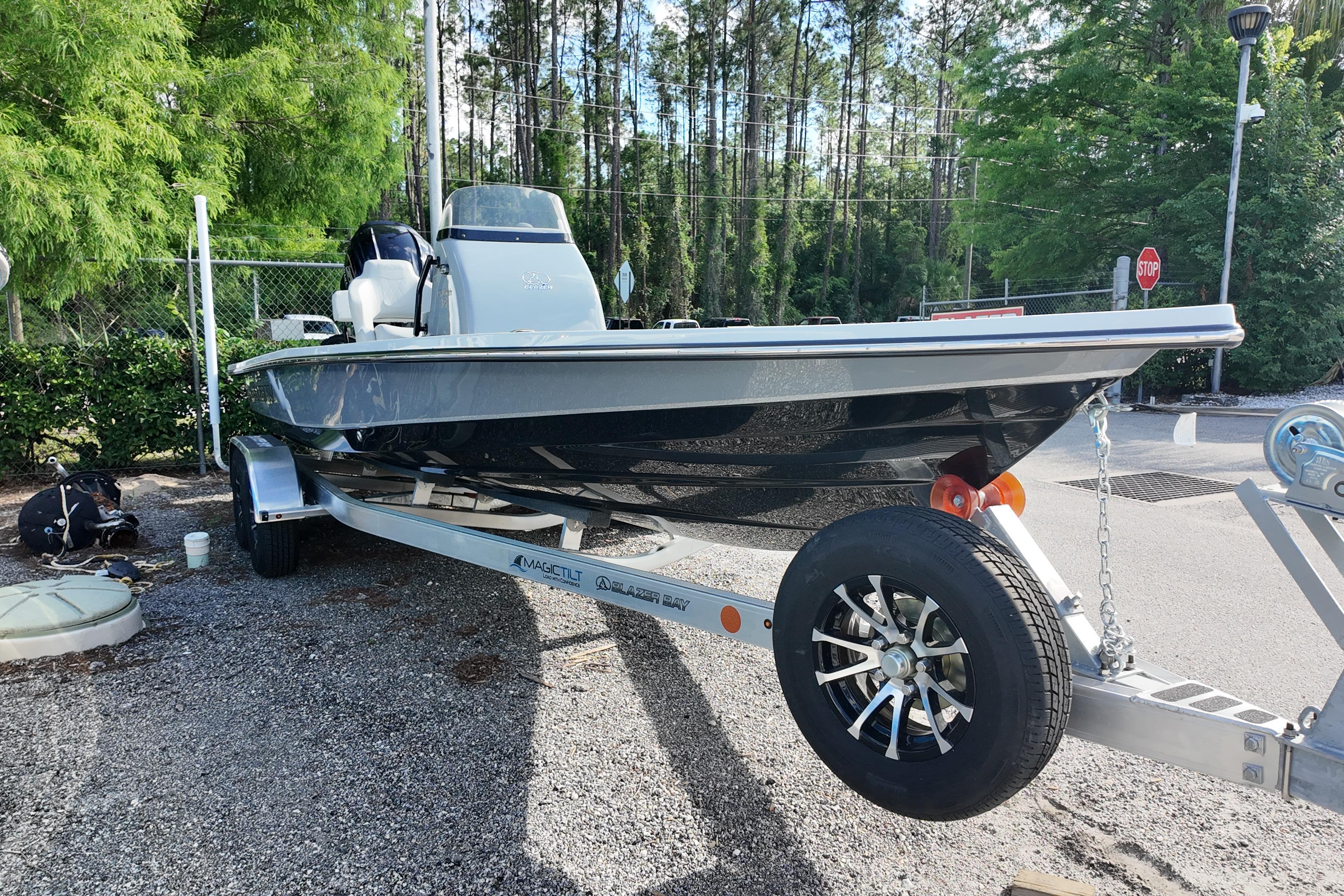 2026 Blazer Bay 675 Ultimate Bay boat on trailer, parked outdoors.